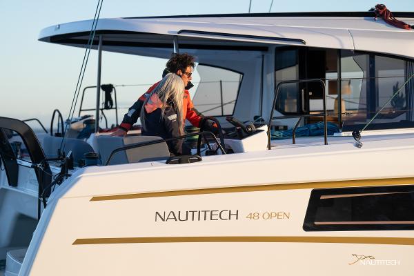 2025 Nautitech 48 Open yacht with people on deck, showcasing modern design and luxury.