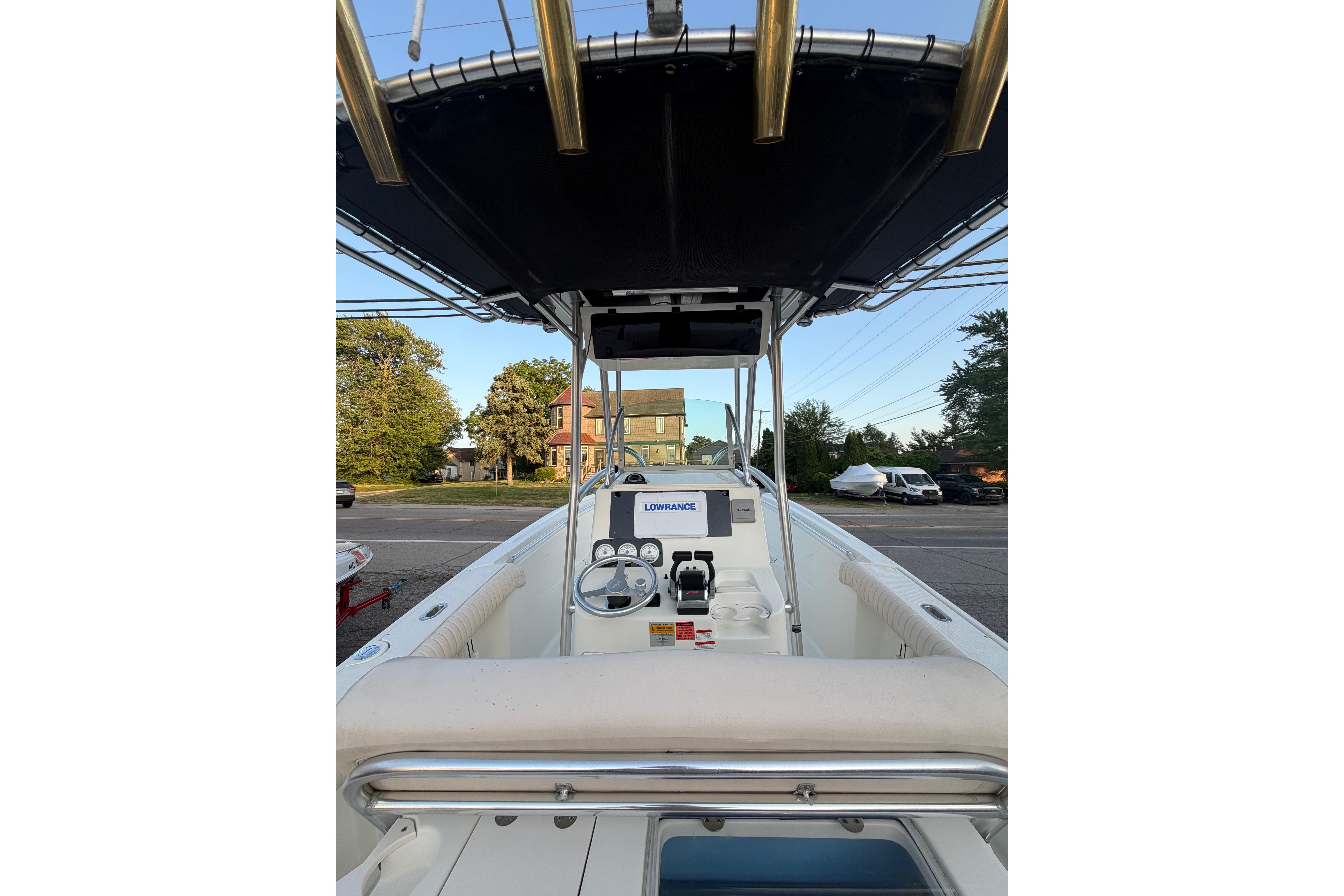 2007 Mako 234 Center Console boat with navigation equipment, parked on a street.