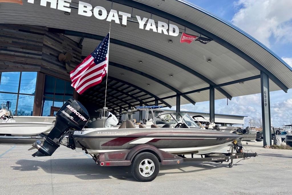 2008 Ranger 180 Reata boat with Mercury engine at The Boat Yard, featuring an American flag.