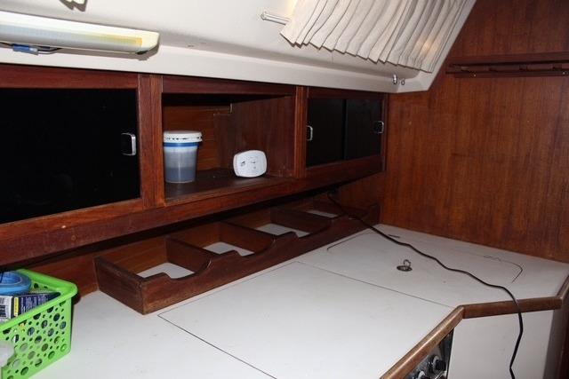 Interior of 1989 Catalina 42 sailboat with wooden cabinets and storage compartments.
