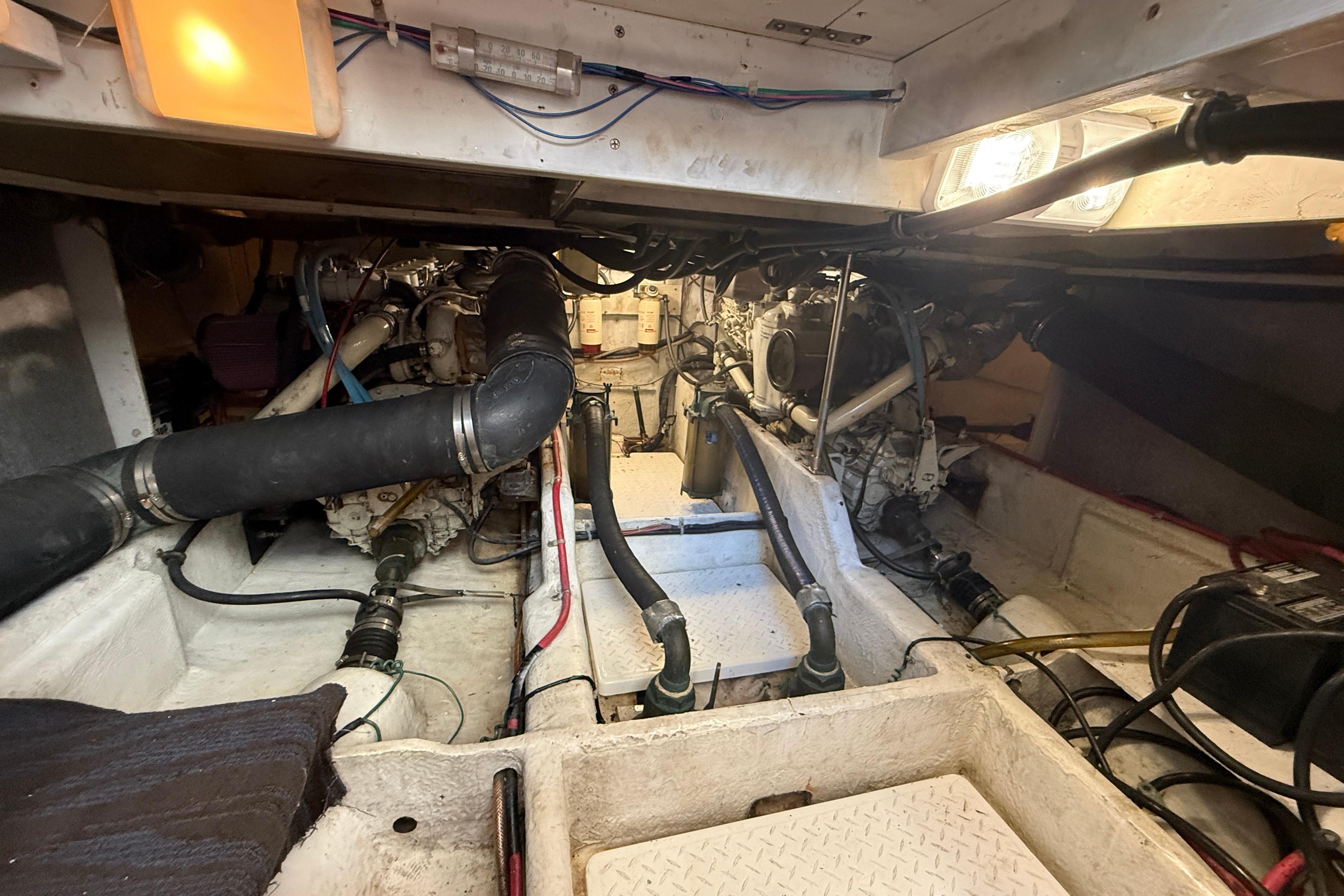 Engine room of a 1997 Bayliner 3988 Command Bridge Motoryacht, showcasing mechanical components.