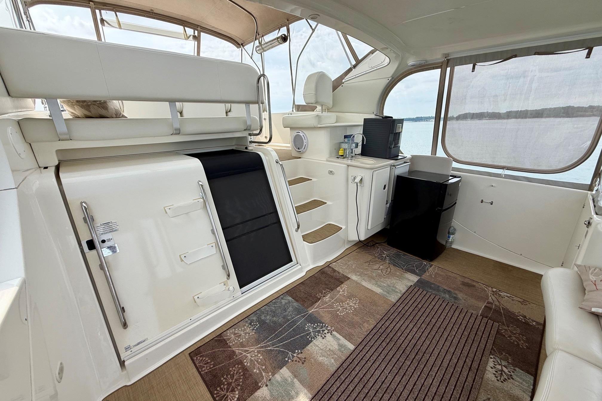 Interior of 2004 Silverton 39 Motor Yacht with seating, steps, and appliances.