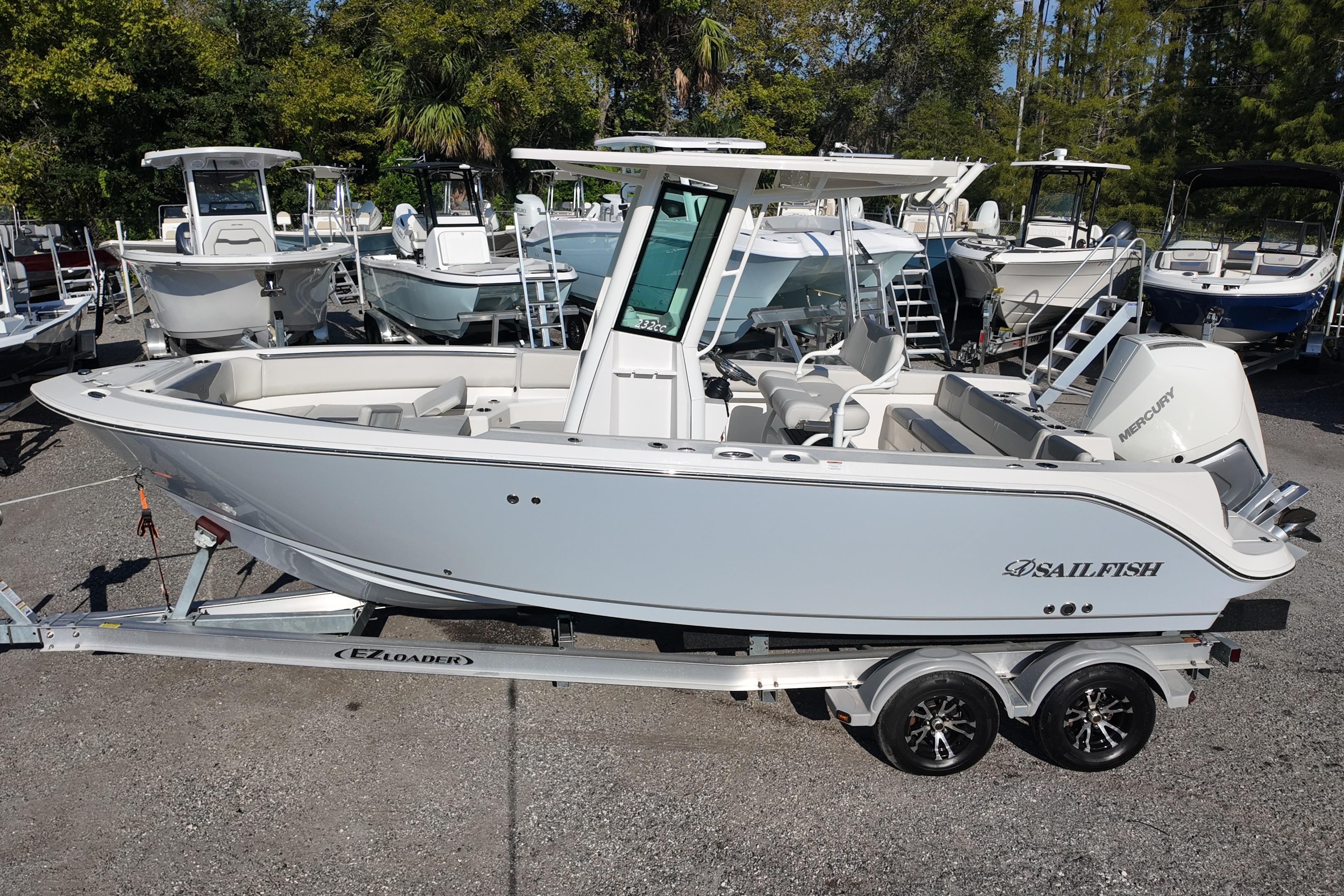 2026 Sailfish 232 CC boat on trailer, surrounded by other boats in a marina.