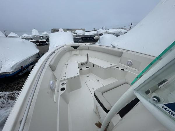 2023 Sailfish 290 CC boat interior with seating, docked among covered boats.