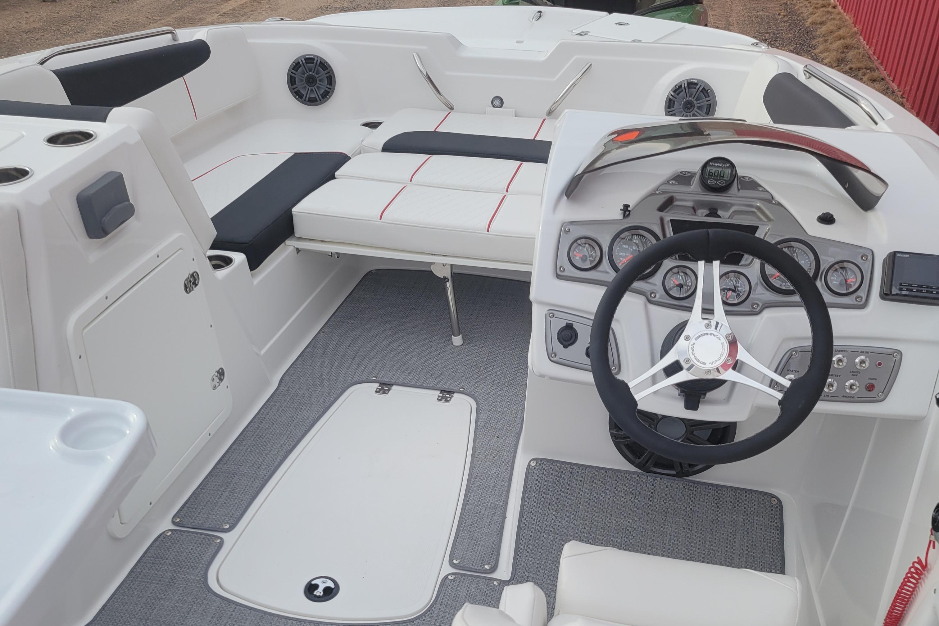 Interior of a 2023 Tahoe 1950 boat featuring steering wheel and seating area.