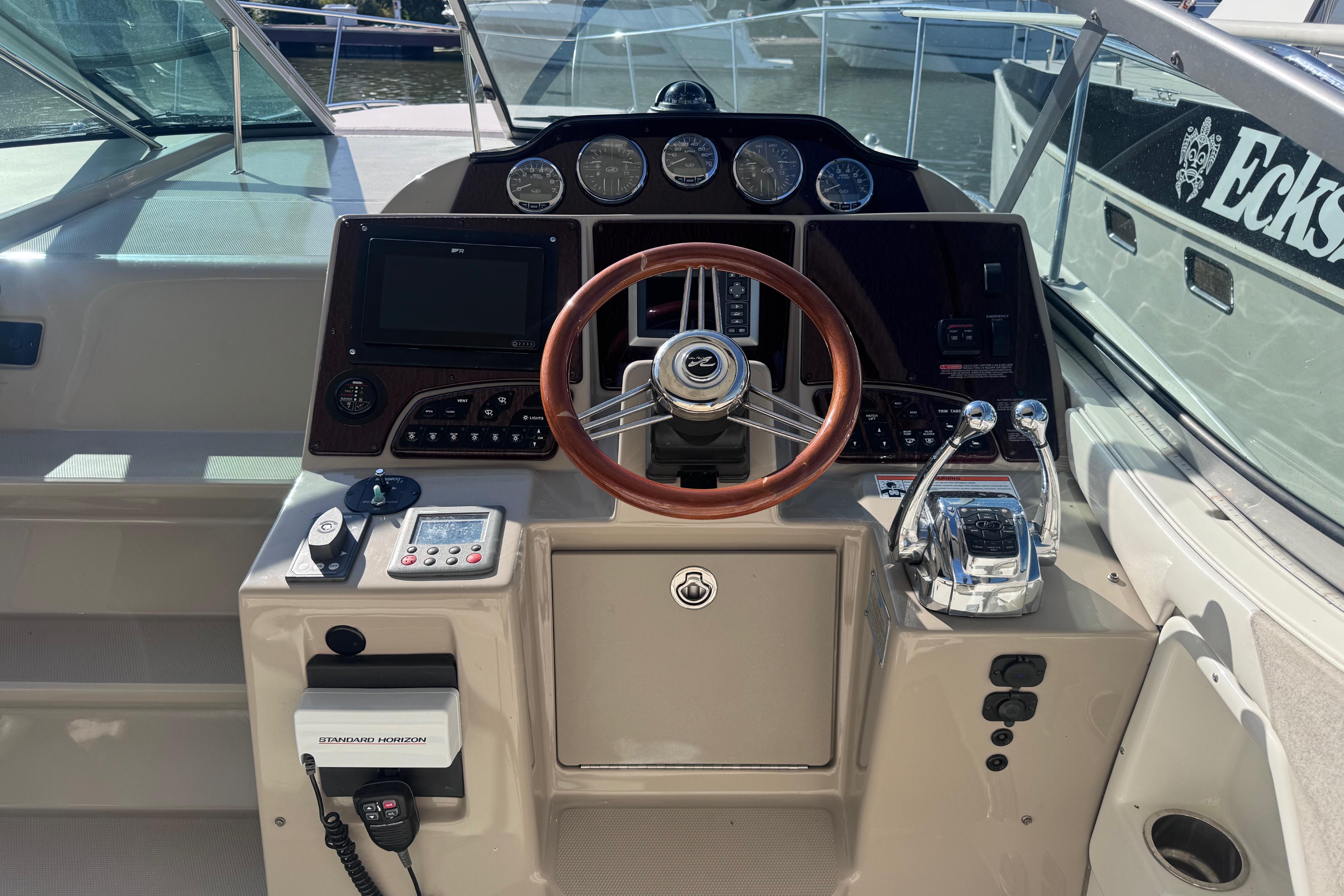 Helm of 2008 Sea Ray 350 Sundancer with steering wheel and control panel.