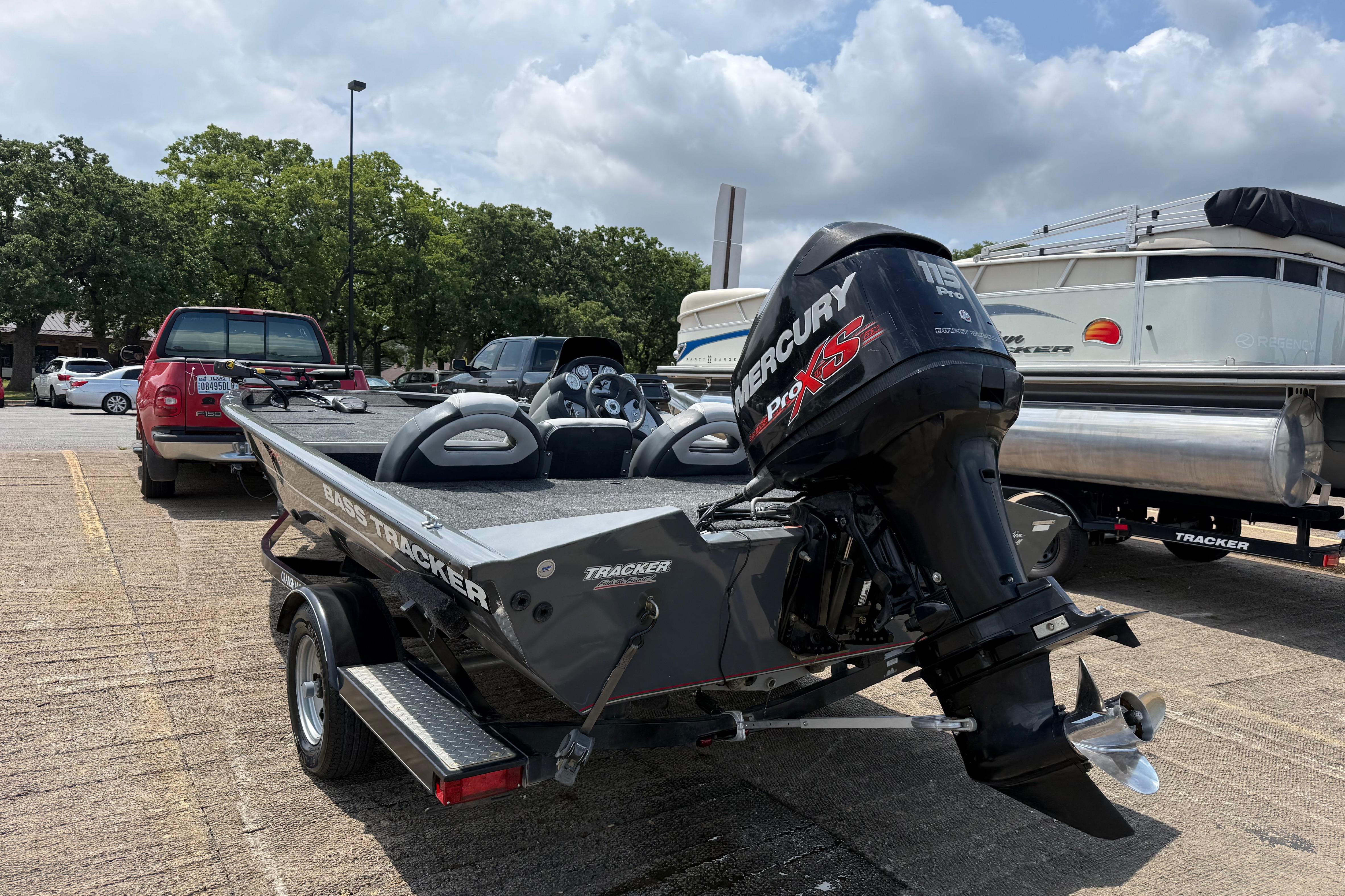 2015 Tracker Pro Team 190 TX boat with Mercury Pro XS engine in parking lot.