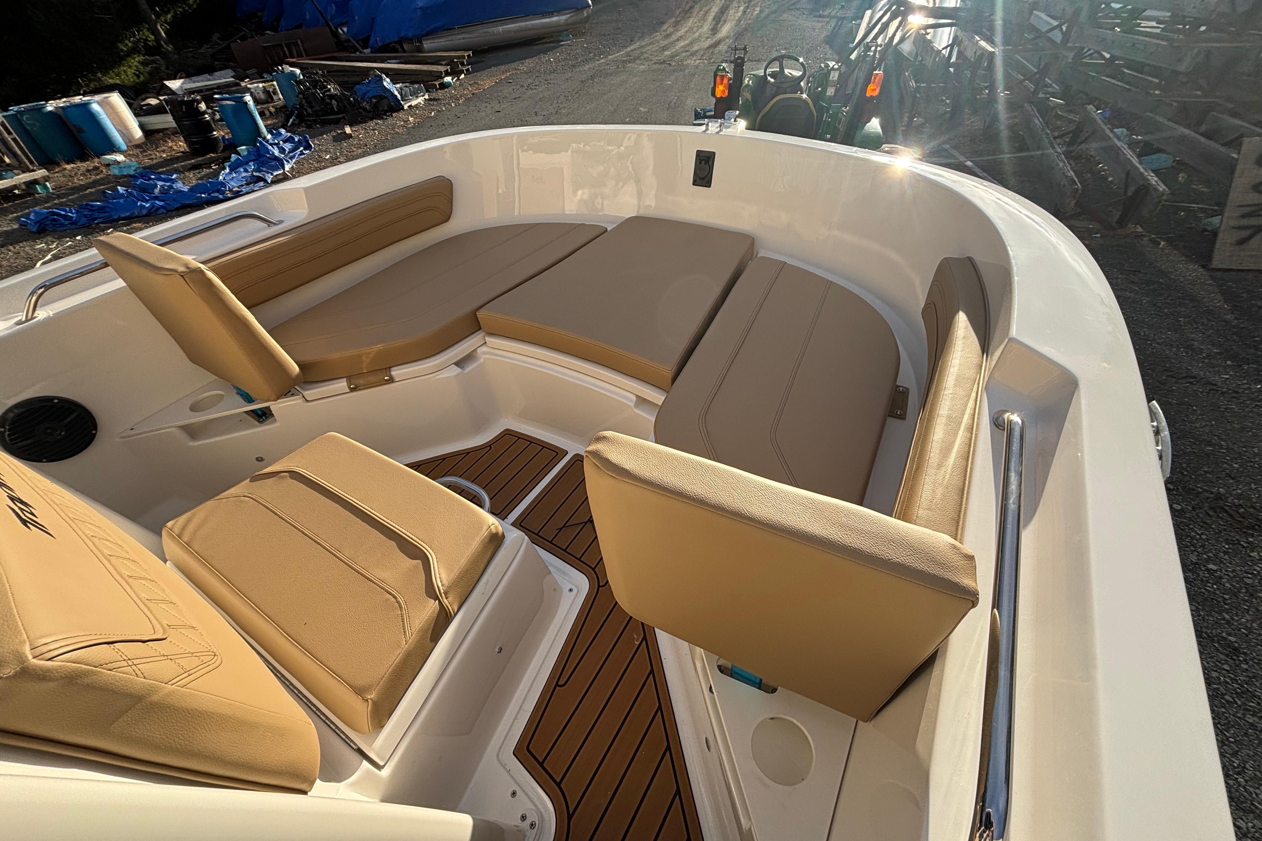 2026 Bayliner Trophy T20CC boat interior with tan seating and wood accents.