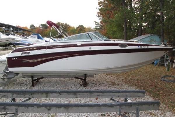 2004 Crownline 288 BR boat on trailer, parked outdoors with trees in background.