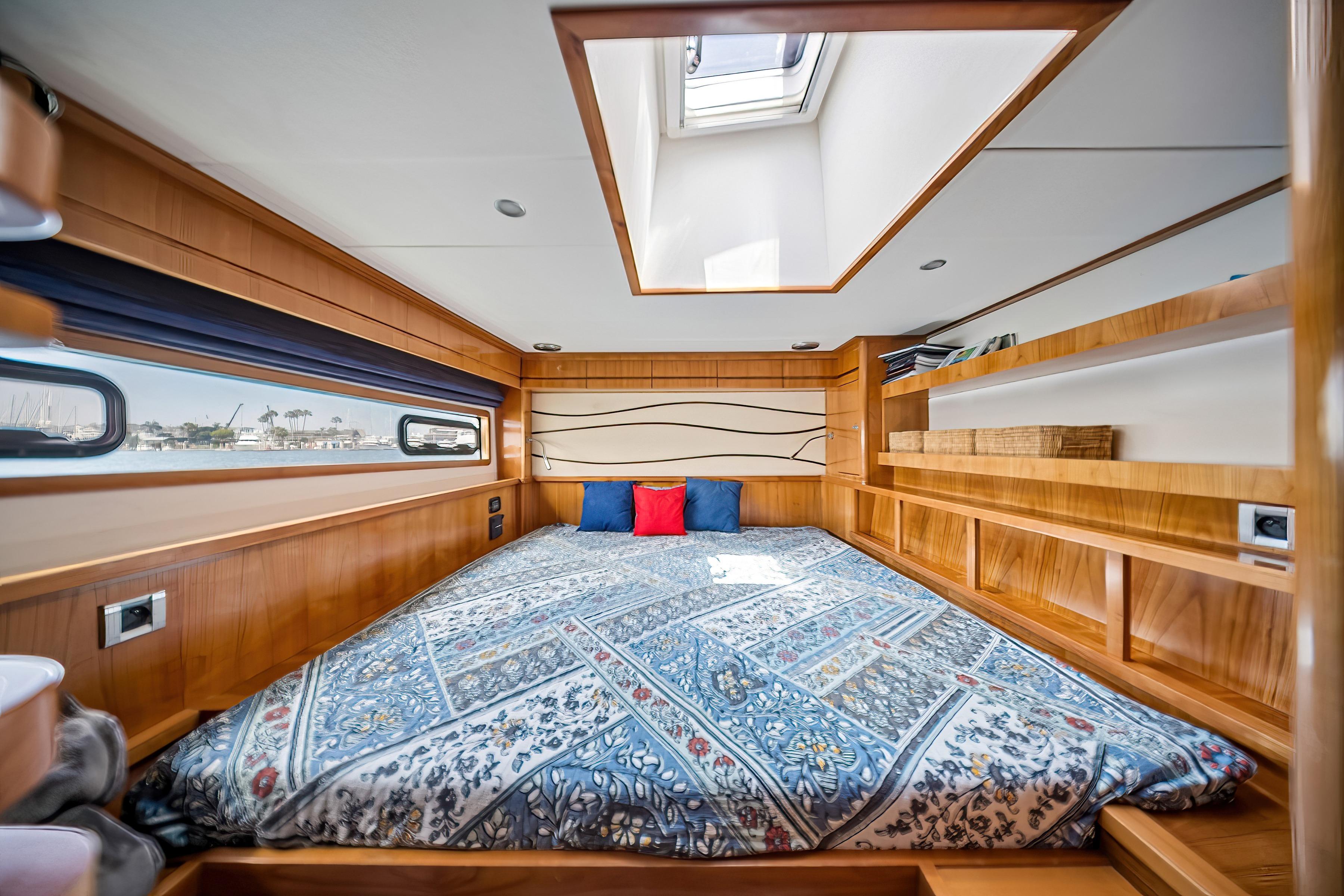 Luxurious cabin interior of 2009 Catana 65 yacht with skylight and elegant bedding.