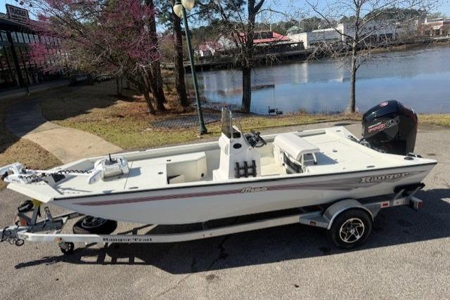 2024 Ranger RB190 boat on trailer by a lakeside, ready for adventure.