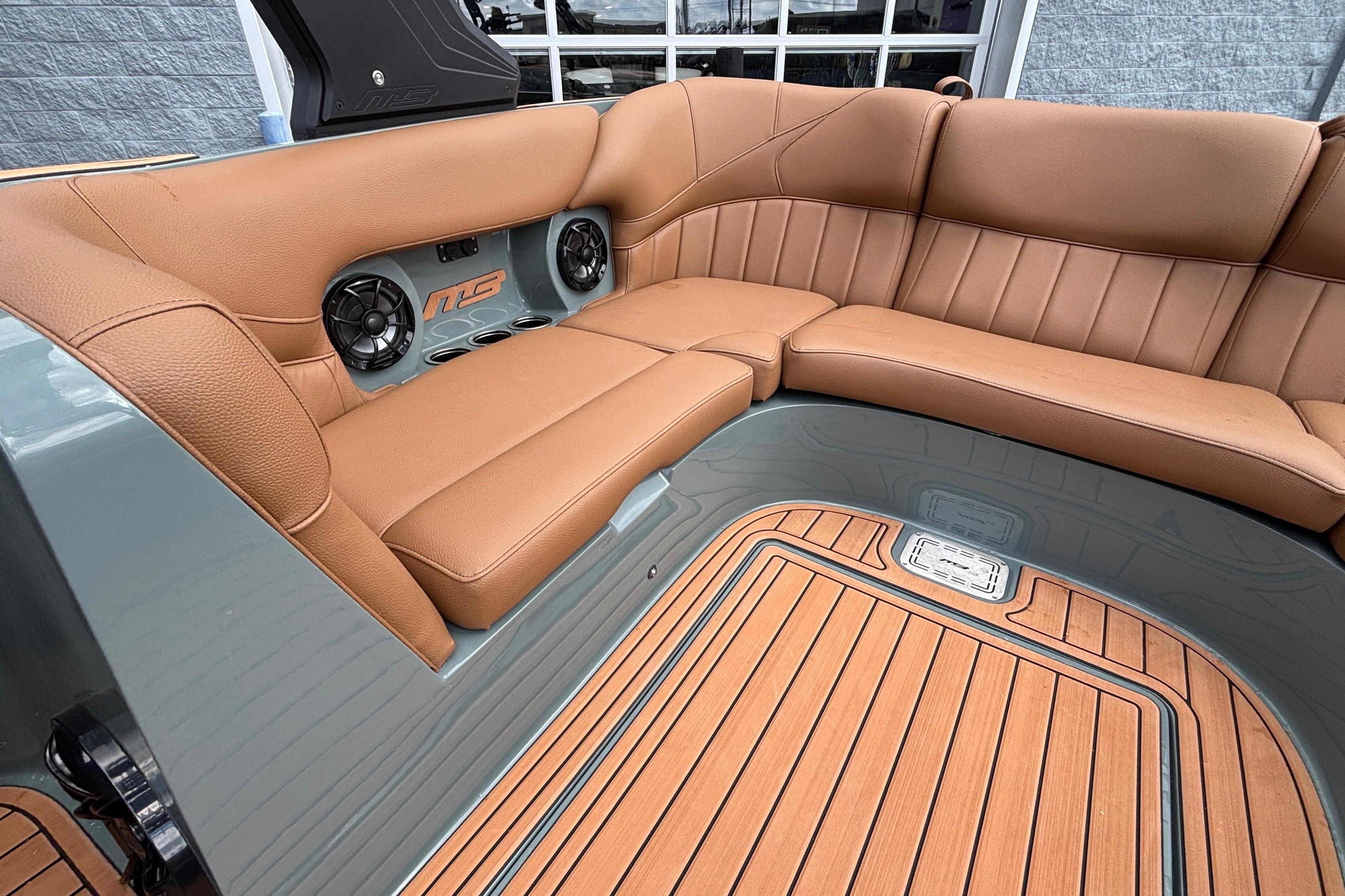 Luxurious interior of 2026 MB B52 23 Classic boat with tan leather seating.