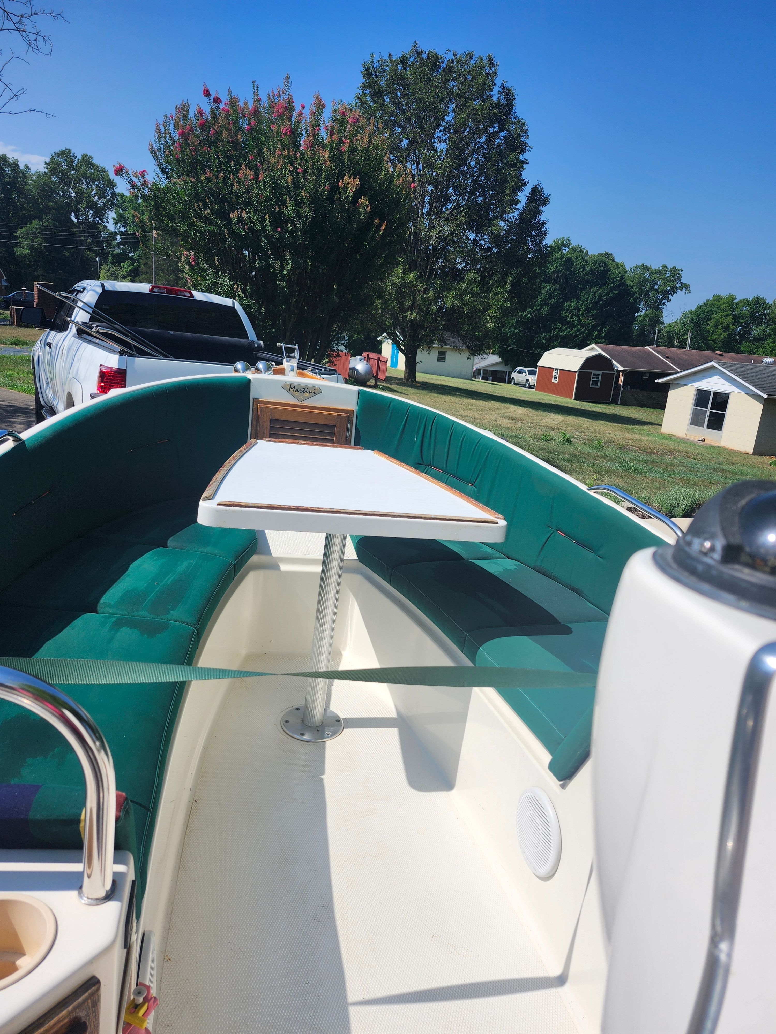 The image shows the interior of a 2000 Ranger Tugs Martini 21 Launch boat with green seating.