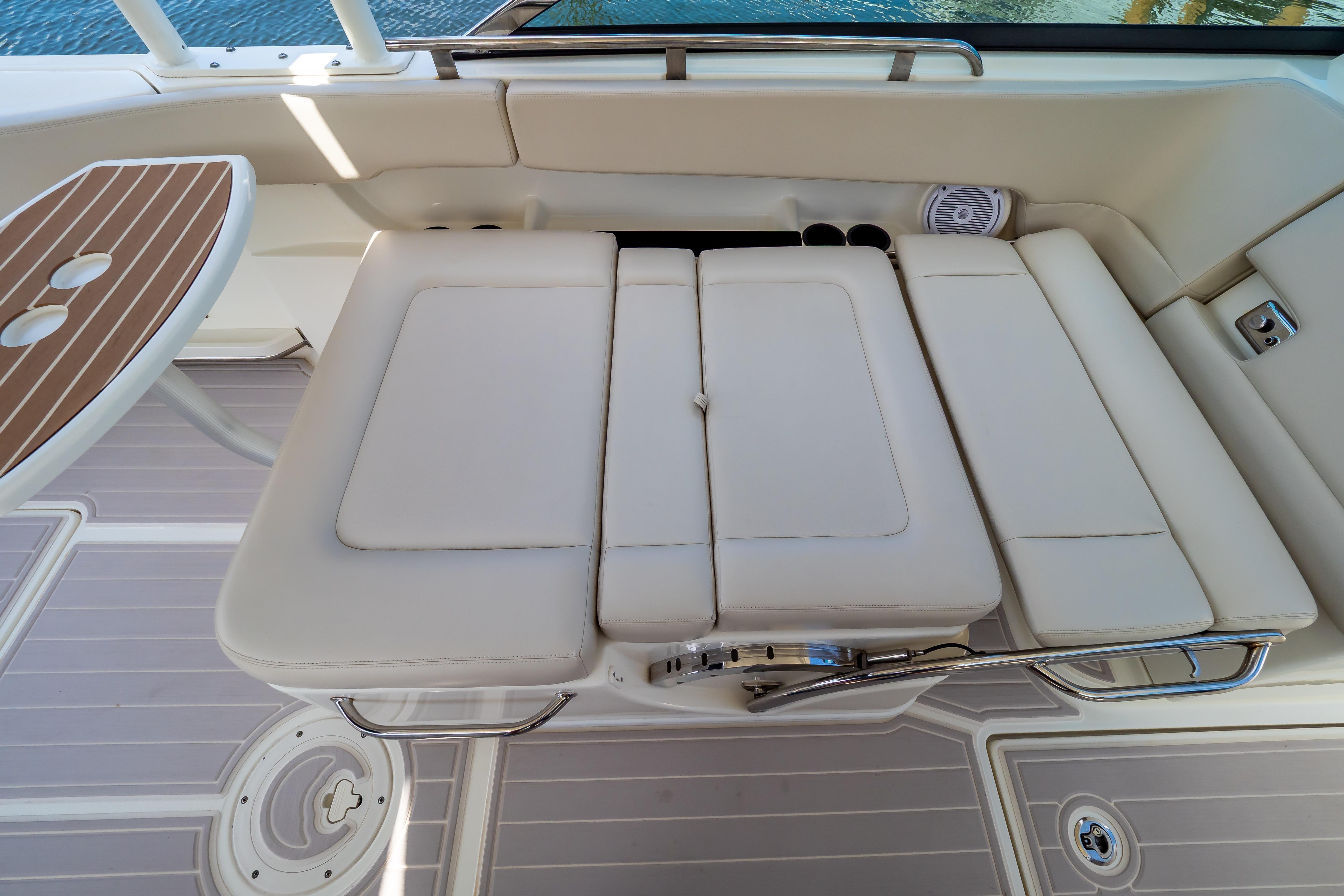 2019 Boston Whaler 270 Vantage interior with cushioned seating and wooden table.