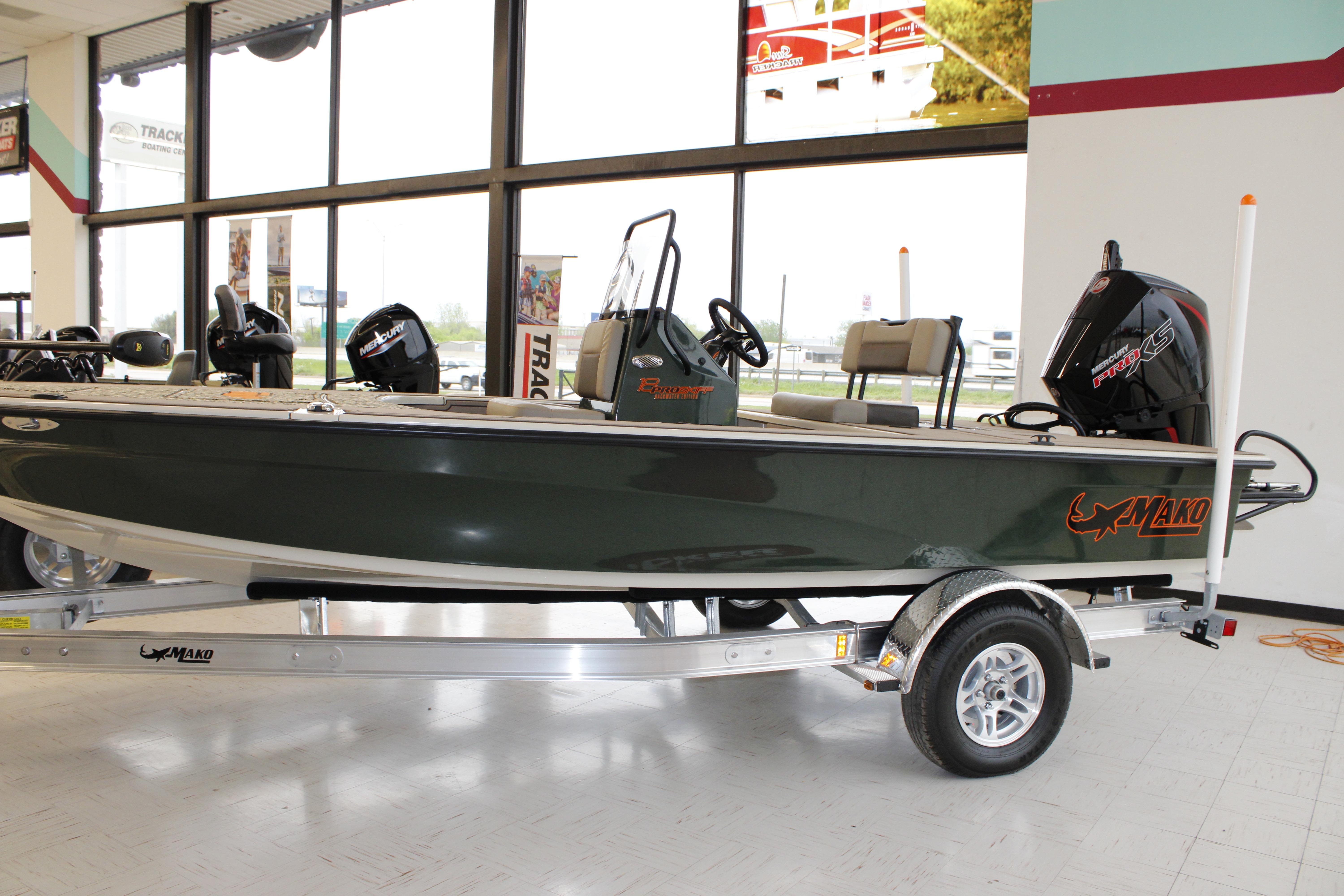 2026 Mako 18 Pro Skiff Backwater Edition boat displayed indoors on a trailer.
