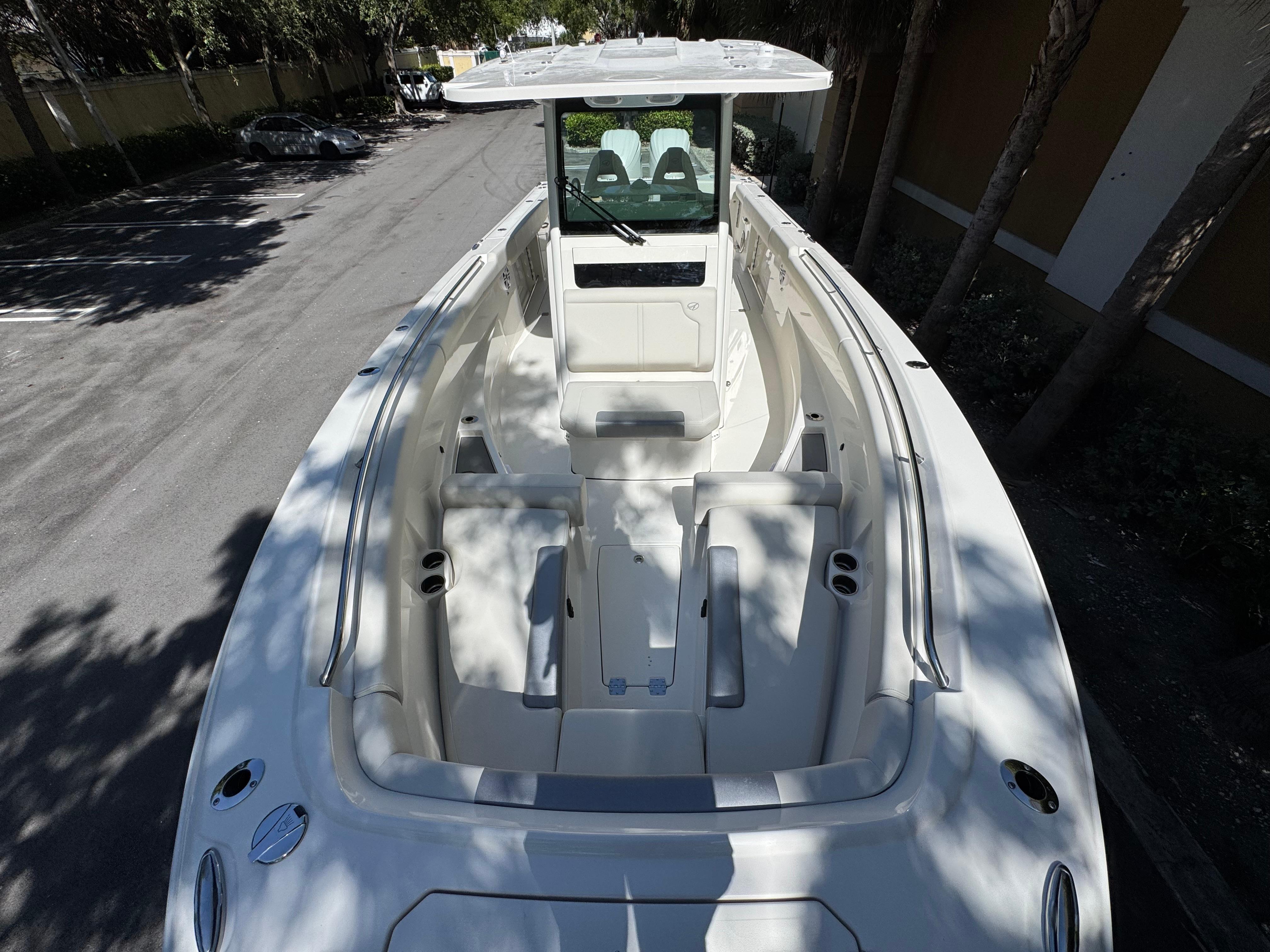 2026 Sailfish 312 CC boat, spacious deck, white interior, parked outdoors.