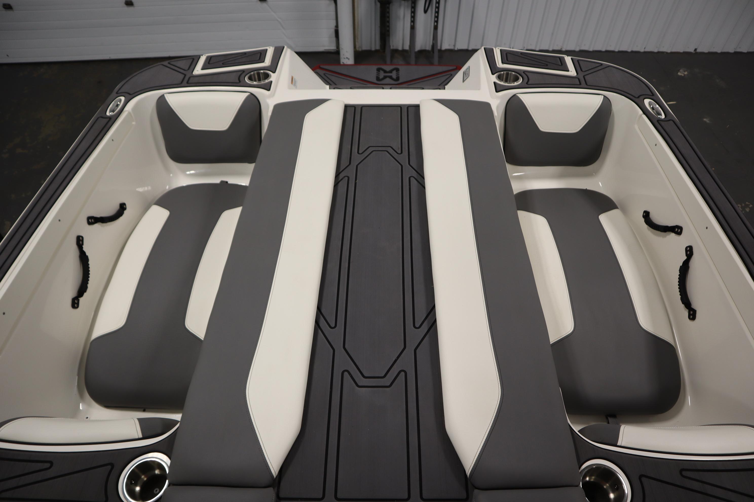 2023 Heyday WT Surf boat interior with gray and white seating and cup holders.