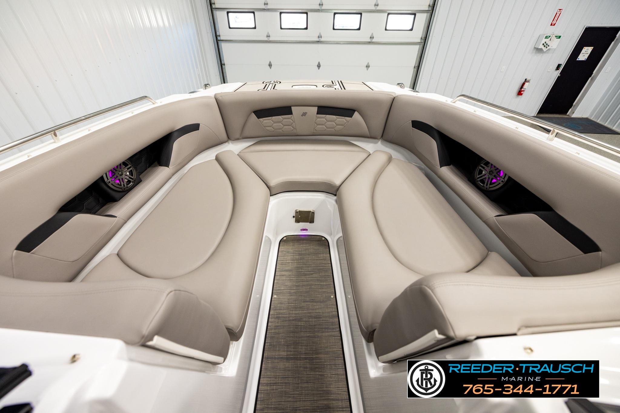 2024 FOURWINNS HD5 Surf boat interior with beige seating and integrated speakers.