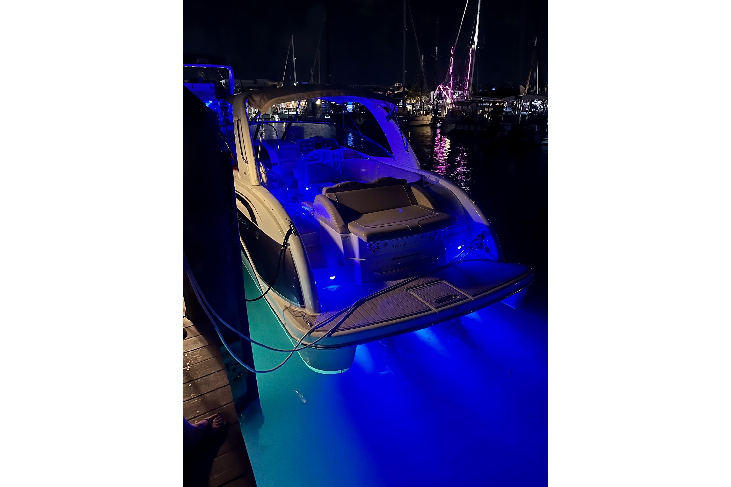 2009 Formula 350 Sun Sport boat with blue underwater lights at night.