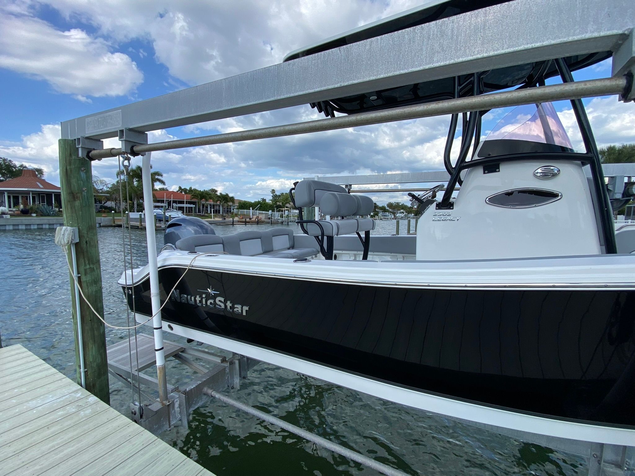NauticStar Legacy 2021 boat at dock with blue sky.