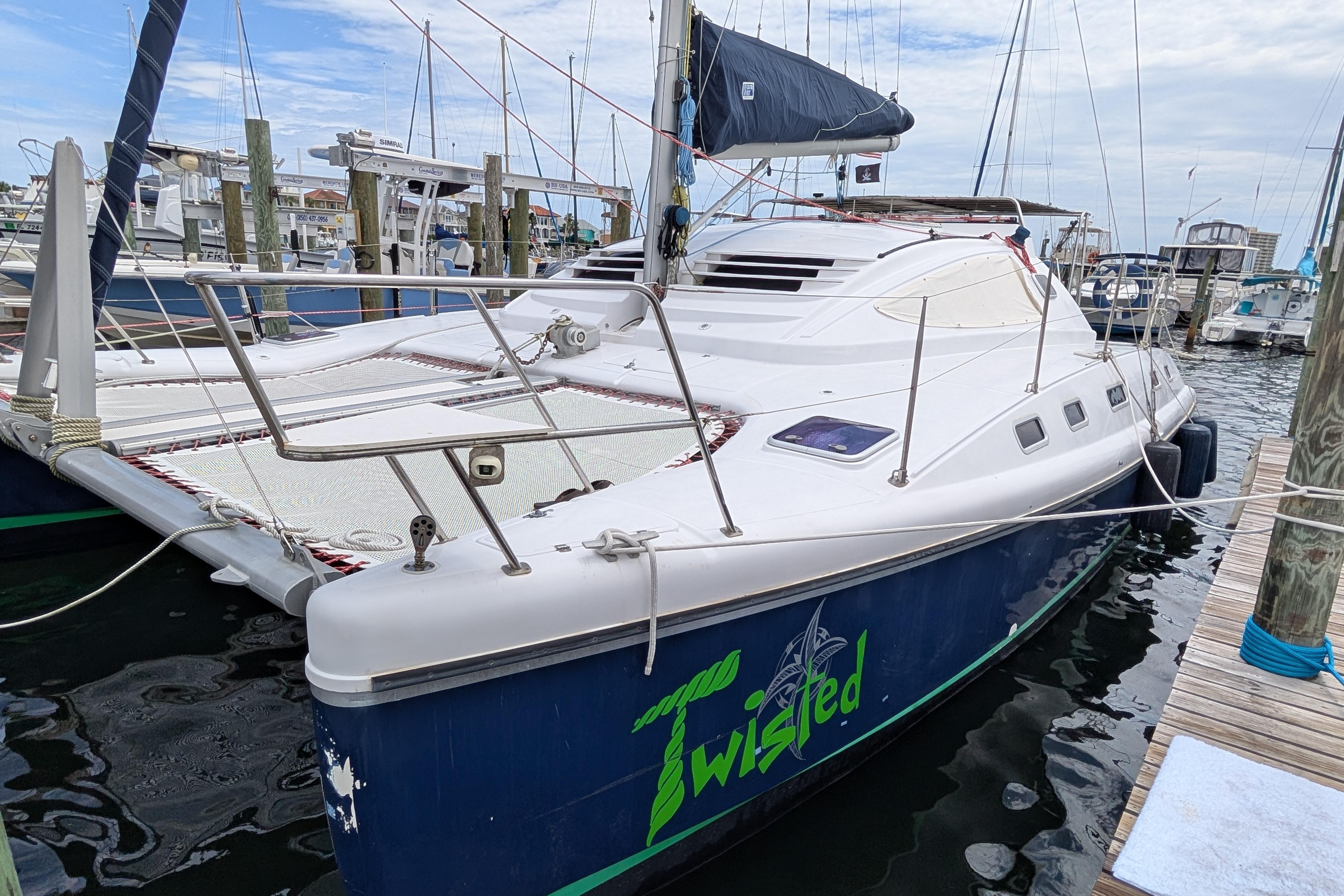 Island Spirit 37 catamaran, 1999 model, docked at marina with "Twisted" logo.