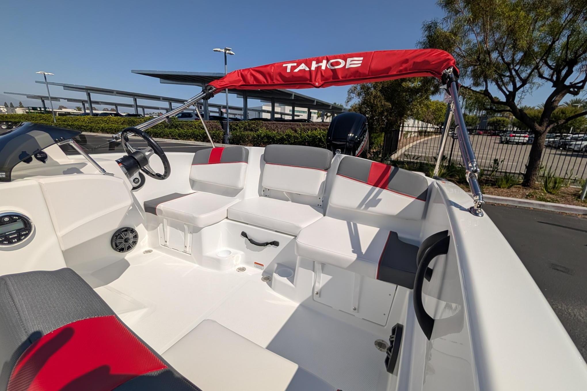 2026 Tahoe T16 boat interior with red and gray seating, steering wheel, and canopy.