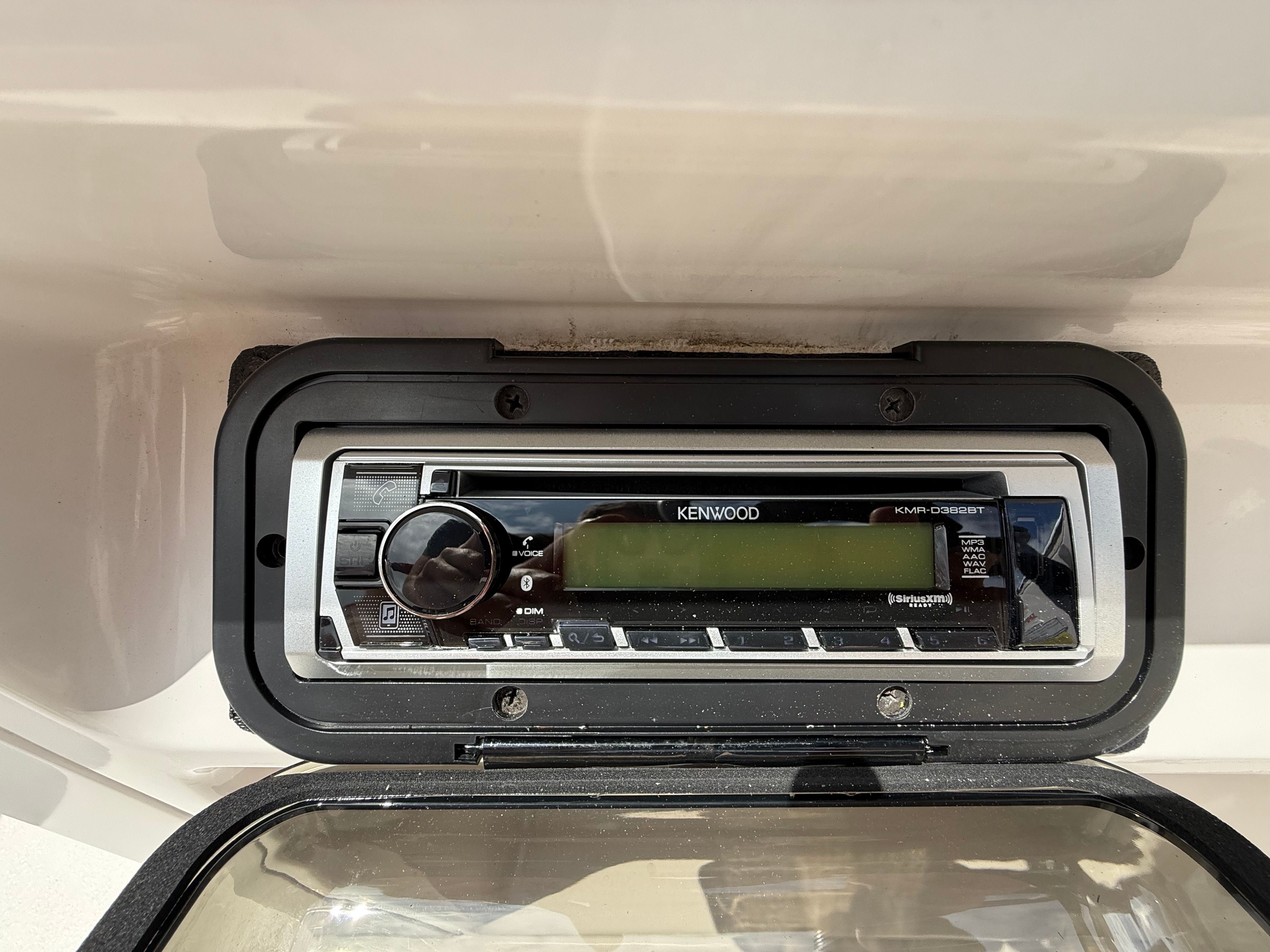 A Kenwood car stereo is installed in a boat.