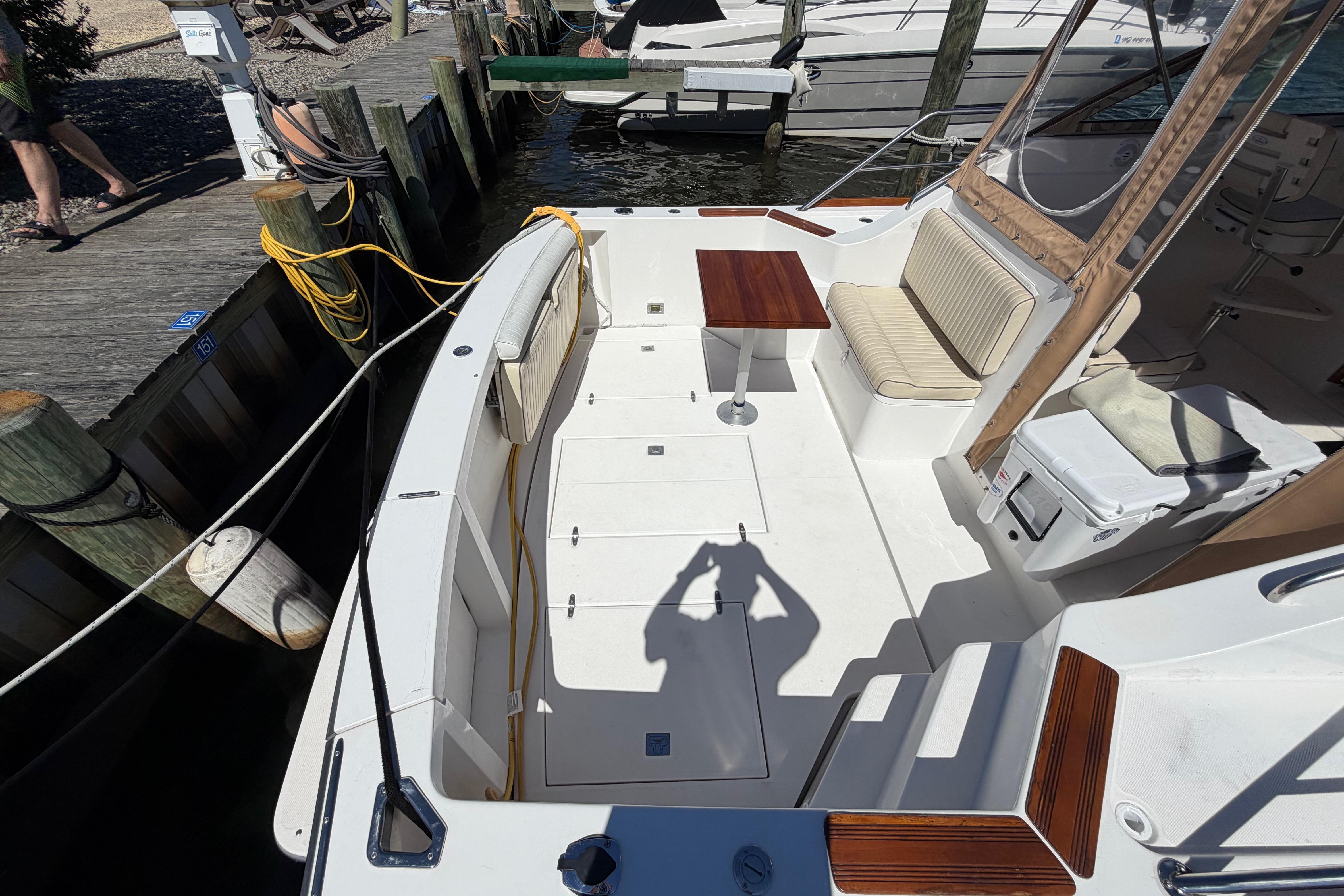 2000 Sabreline 36 Express boat interior with seating, table, and dockside view.