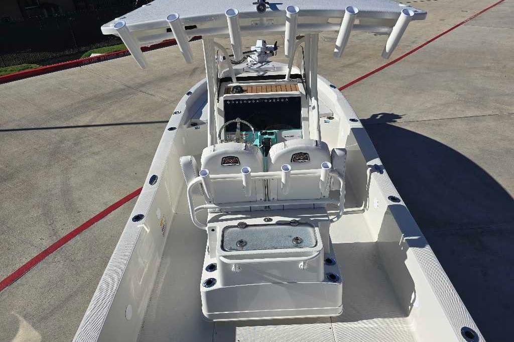 2025 Ranger 2510 Bay boat with center console and rod holders, docked on concrete.