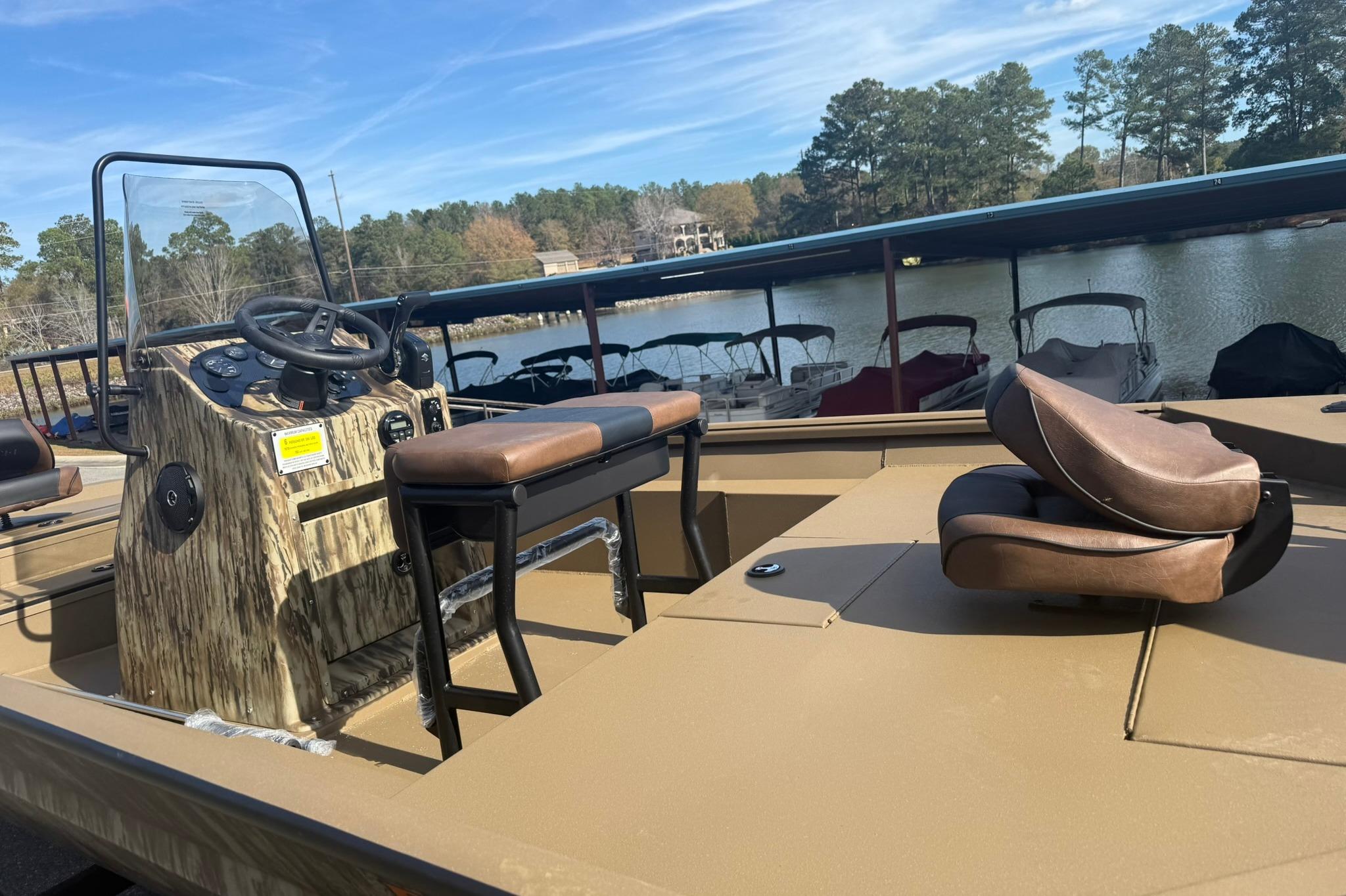 2026 Excel 206 Stalker CC boat with seating, steering console, and lake view.
