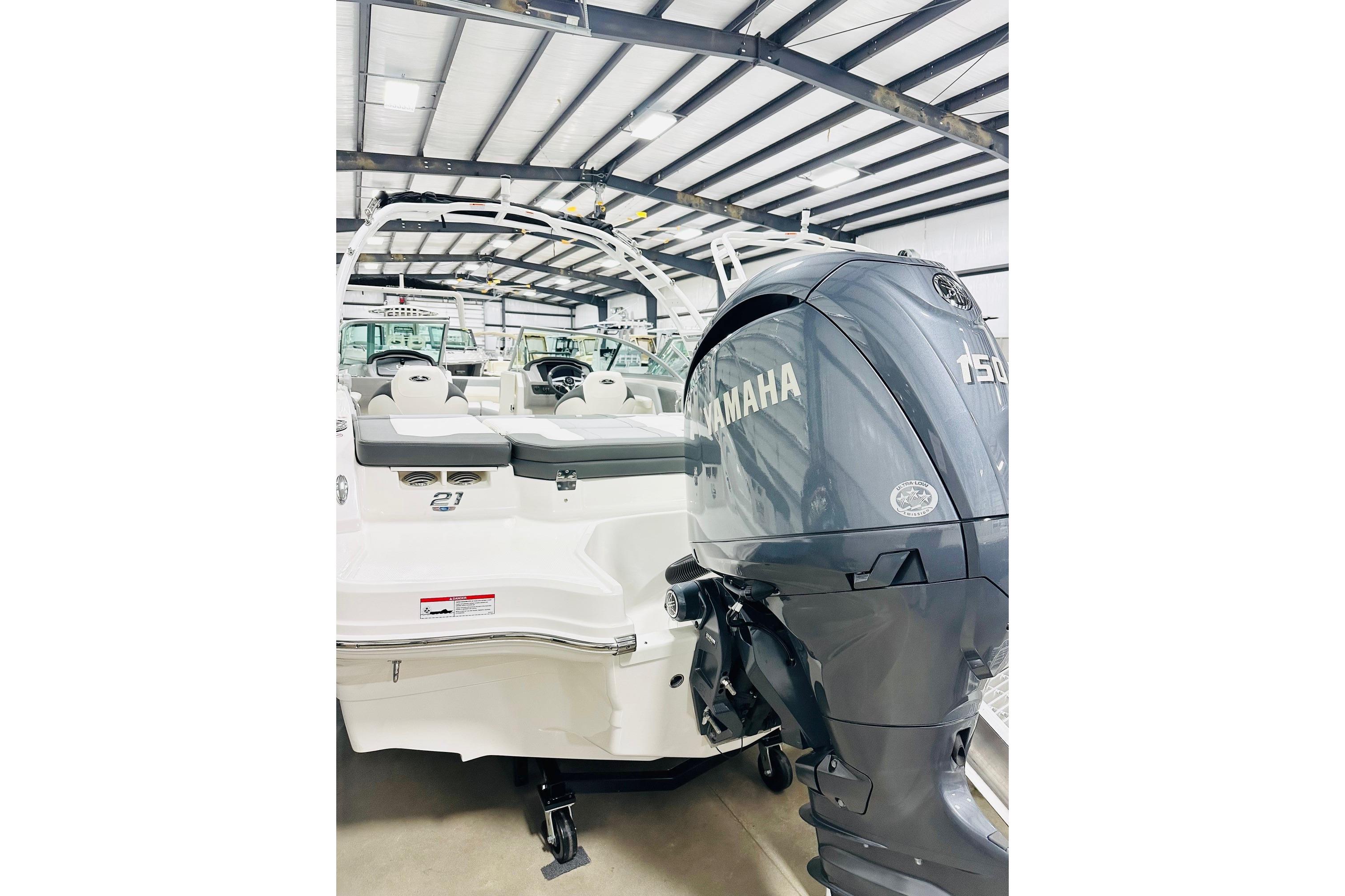 2025 Chaparral 21 SSi OB boat with Yamaha 150 outboard motor in showroom.