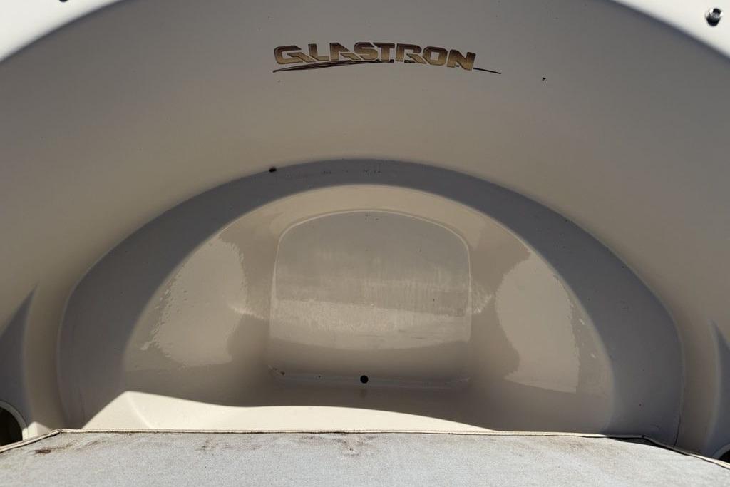 1999 Glastron GT 225 boat interior with logo, showcasing sleek design.