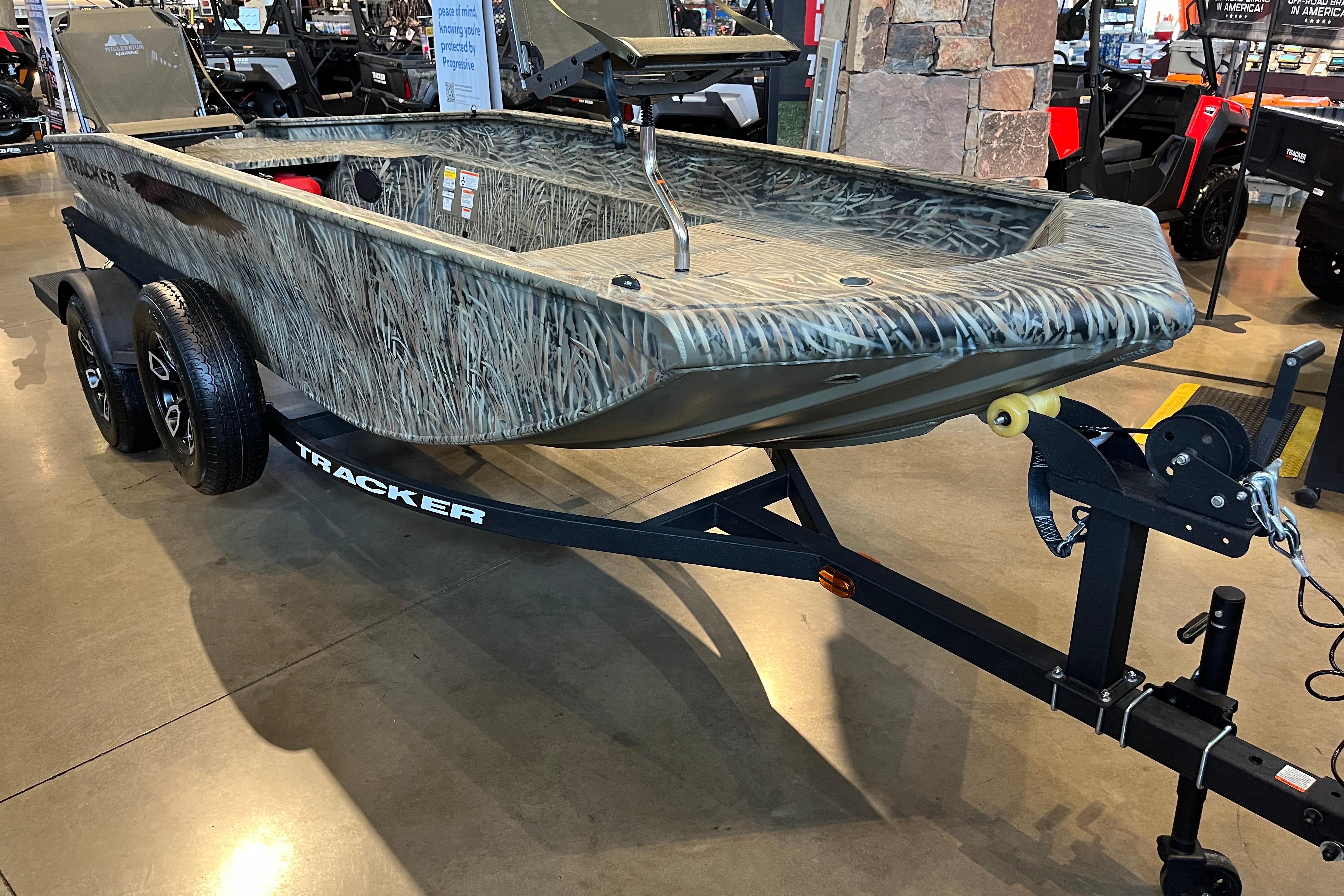 2026 Tracker Grizzly 1654 T Sportsman boat on trailer in showroom.