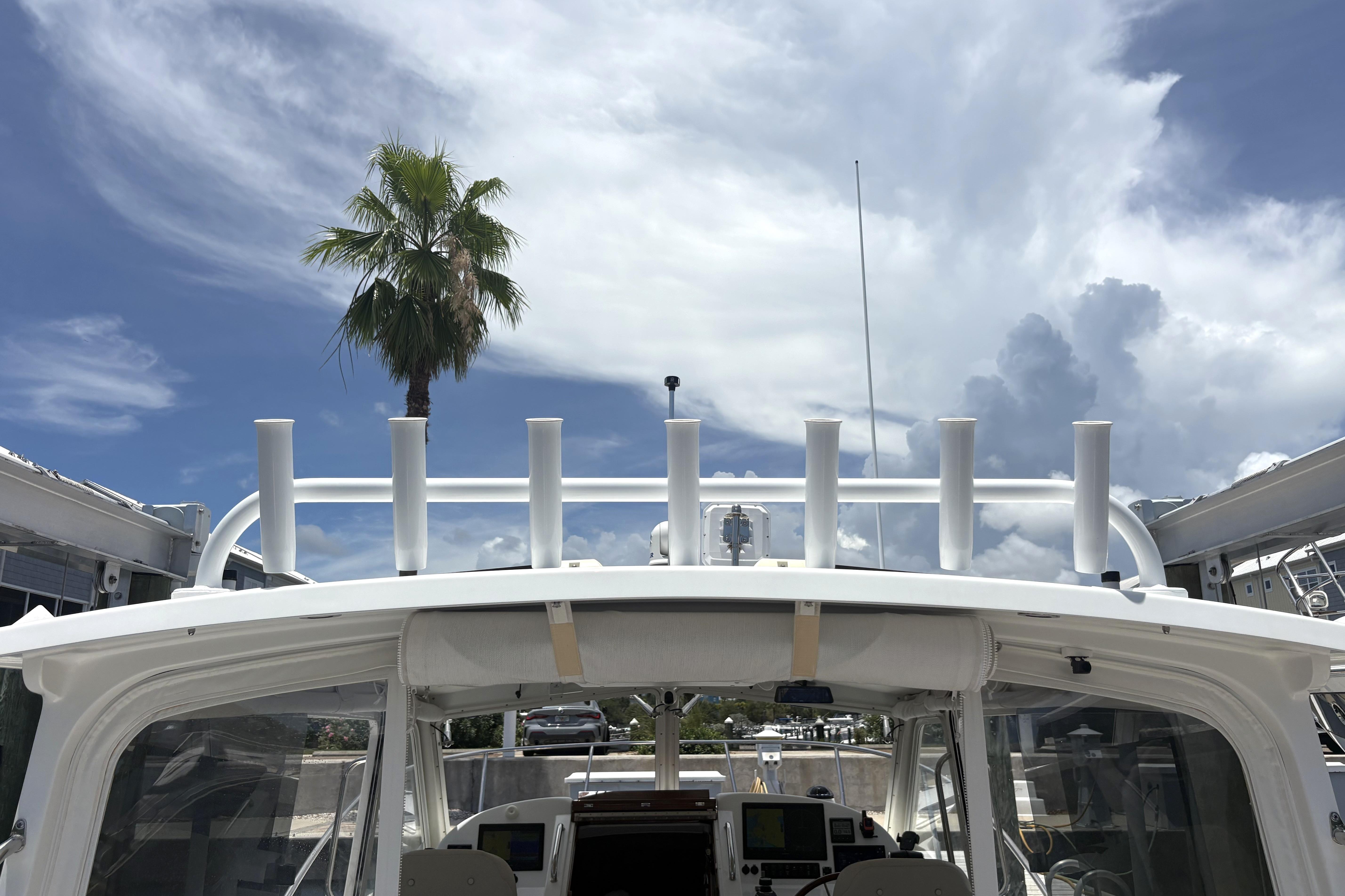 2024 MJM 35z boat with clear sky and palm tree in background.