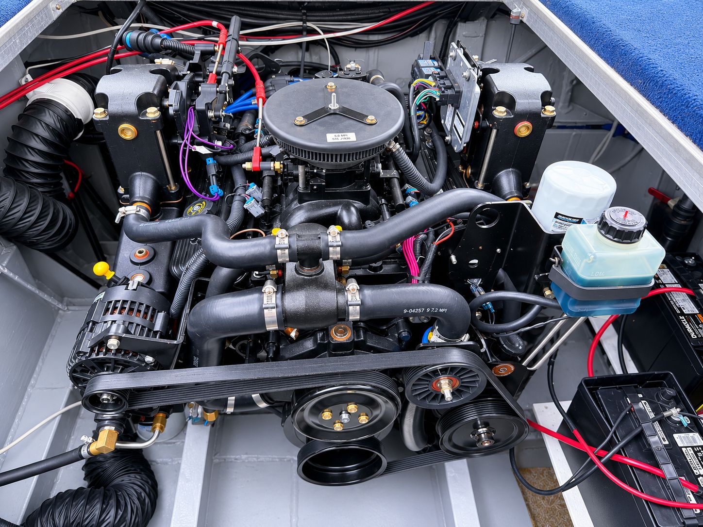Engine compartment of a houseboat with visible wires and components.