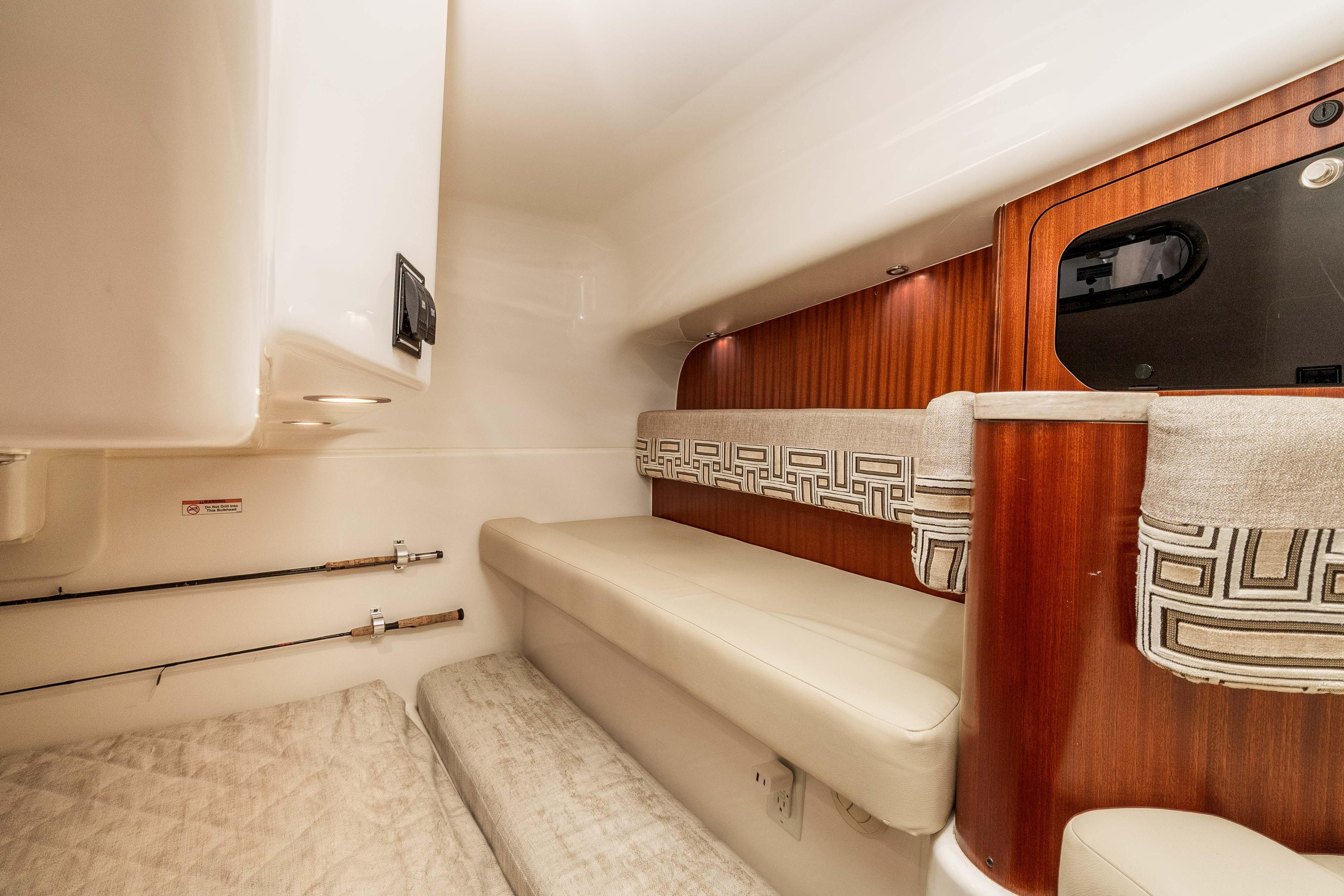 2022 Pursuit OS 385 Offshore cabin interior with wood accents and comfortable seating.