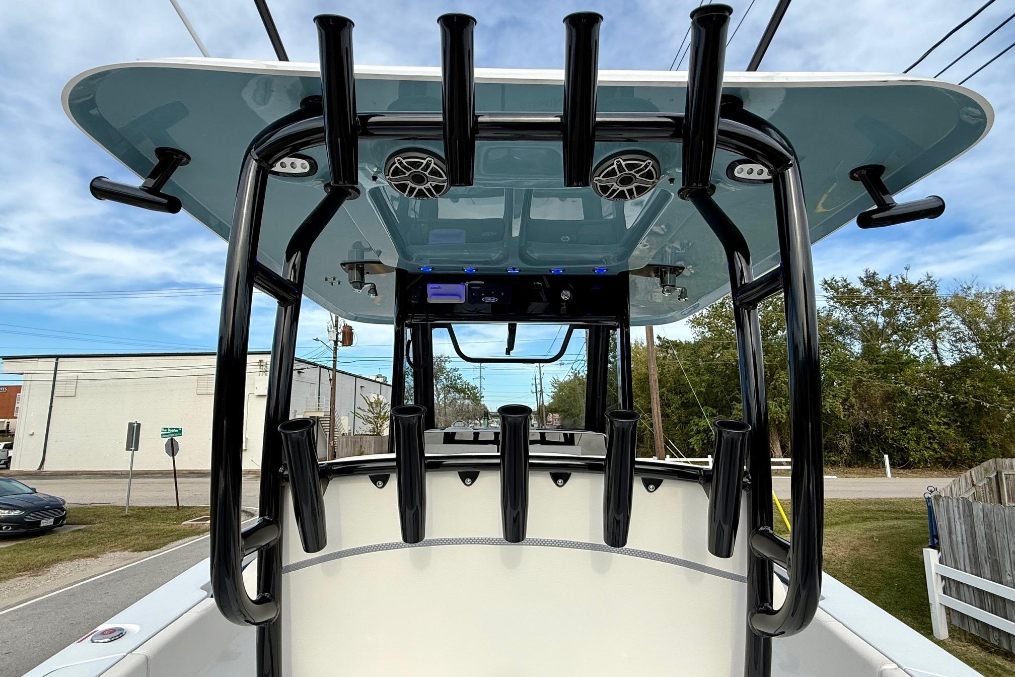 2026 Sea Hunt Gamefish 30 Coffin Box boat with rod holders and speakers, viewed from the rear.