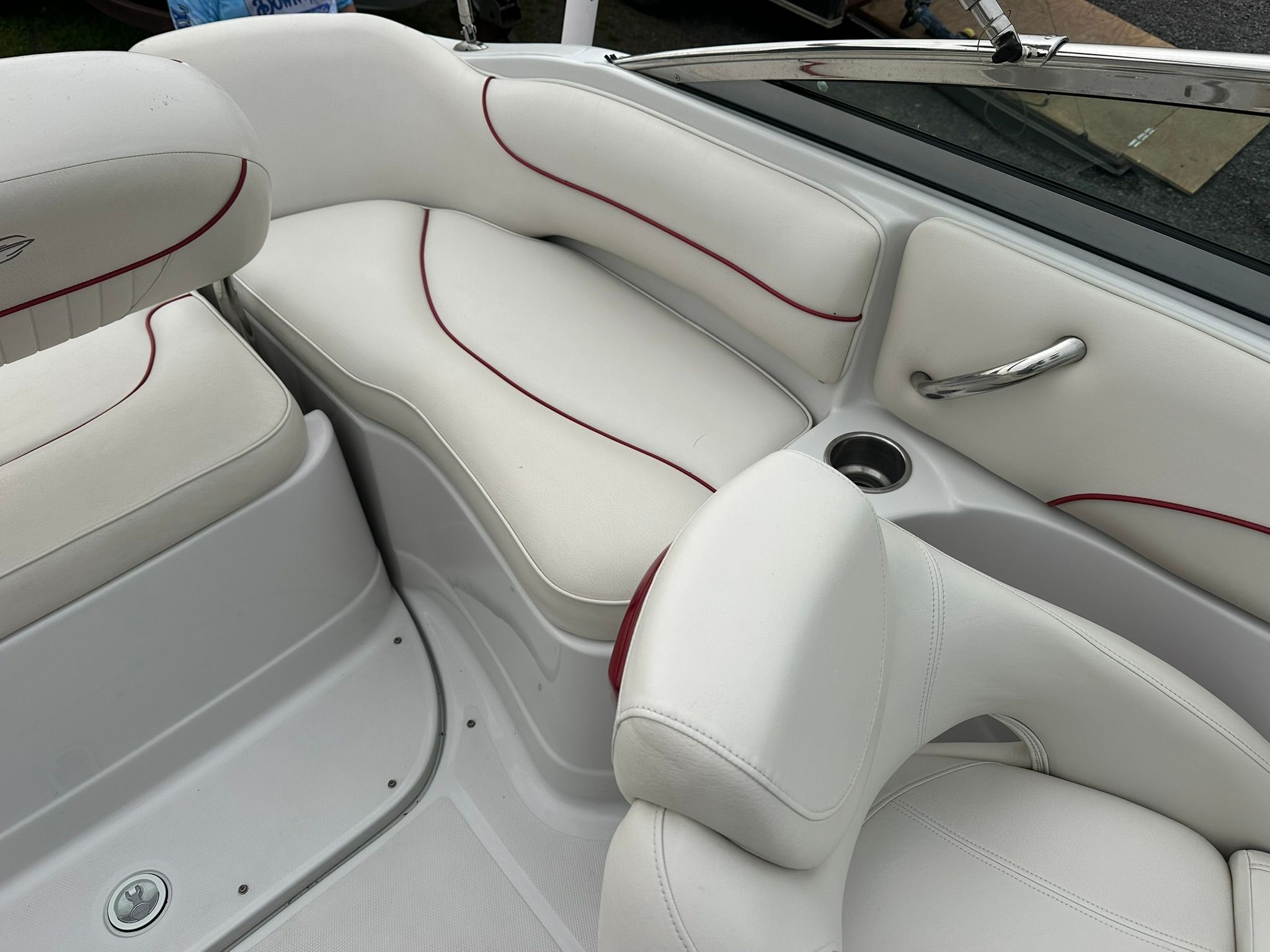 Interior of a 2009 Crownline 220 EX with white upholstery and red accents.