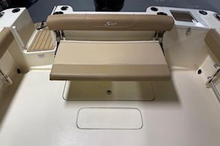 2021 Scout 215 Dorado boat interior with beige seating and storage area.