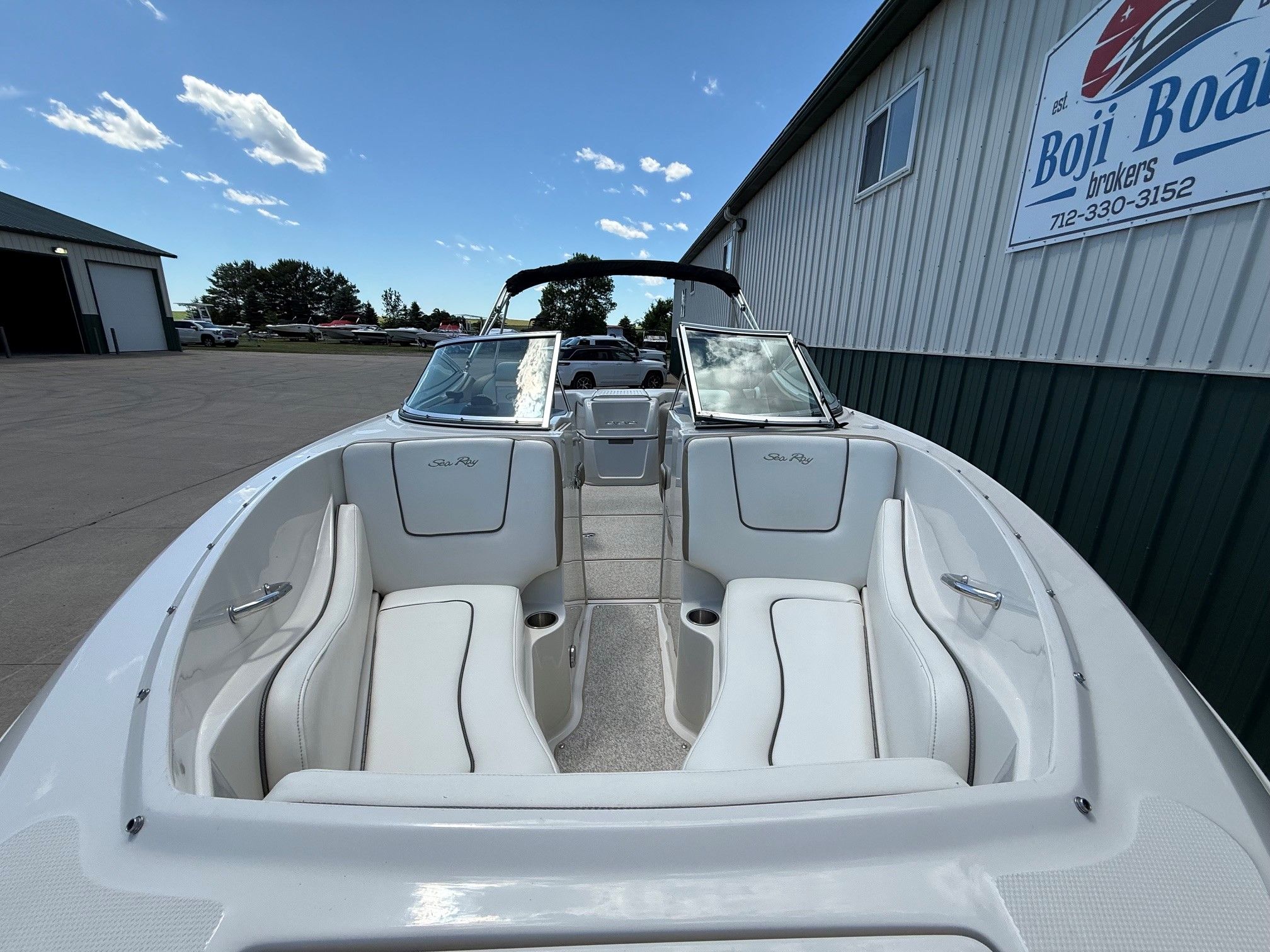 2007 Sea Ray 230 Select boat on a parking lot.