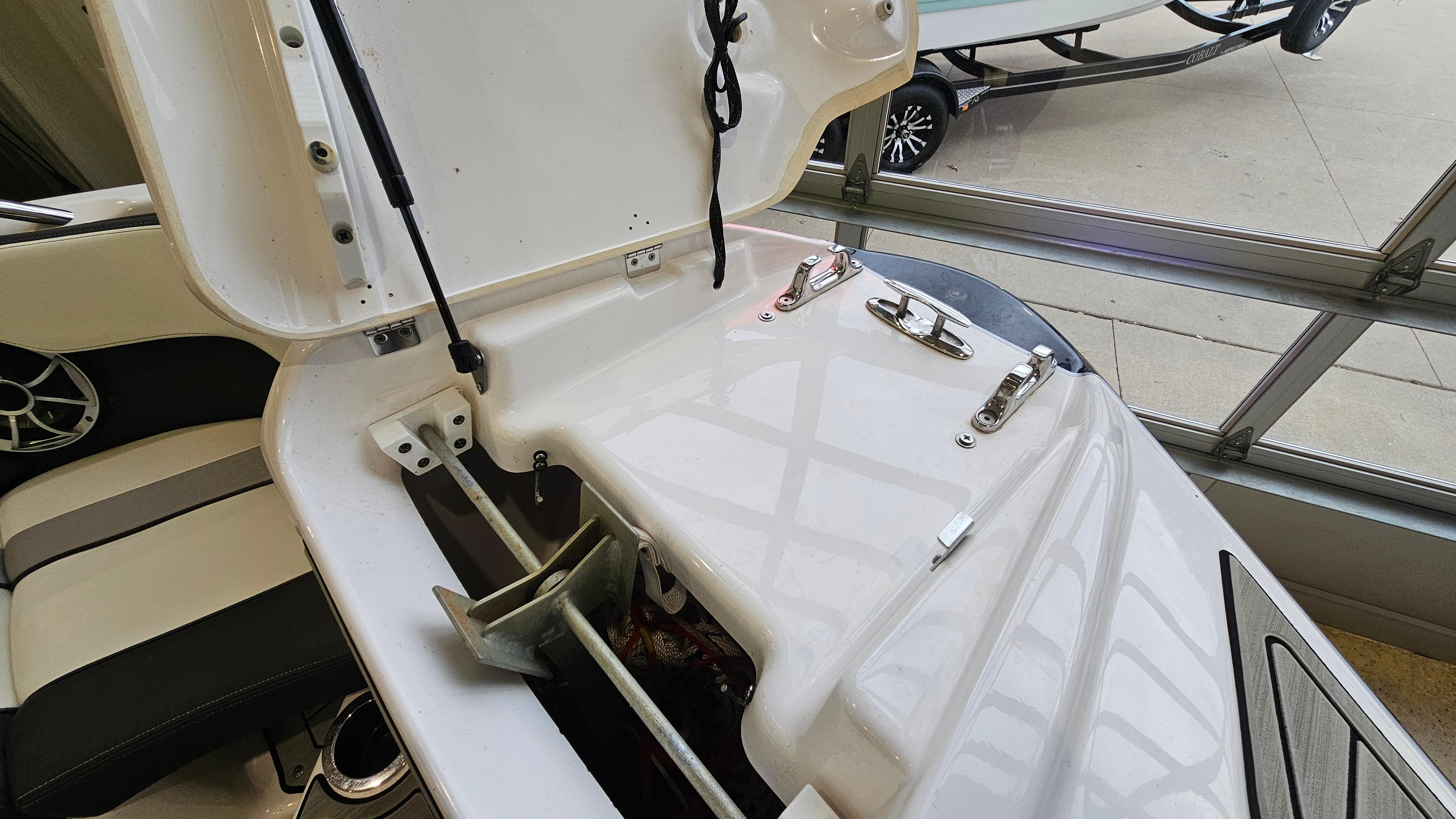 2021 Yamaha Boats 212SD anchor storage compartment with open hatch, showcasing interior details.