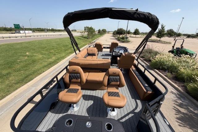 2026 Ranger 223F pontoon boat with tan seating and canopy on a sunny day.