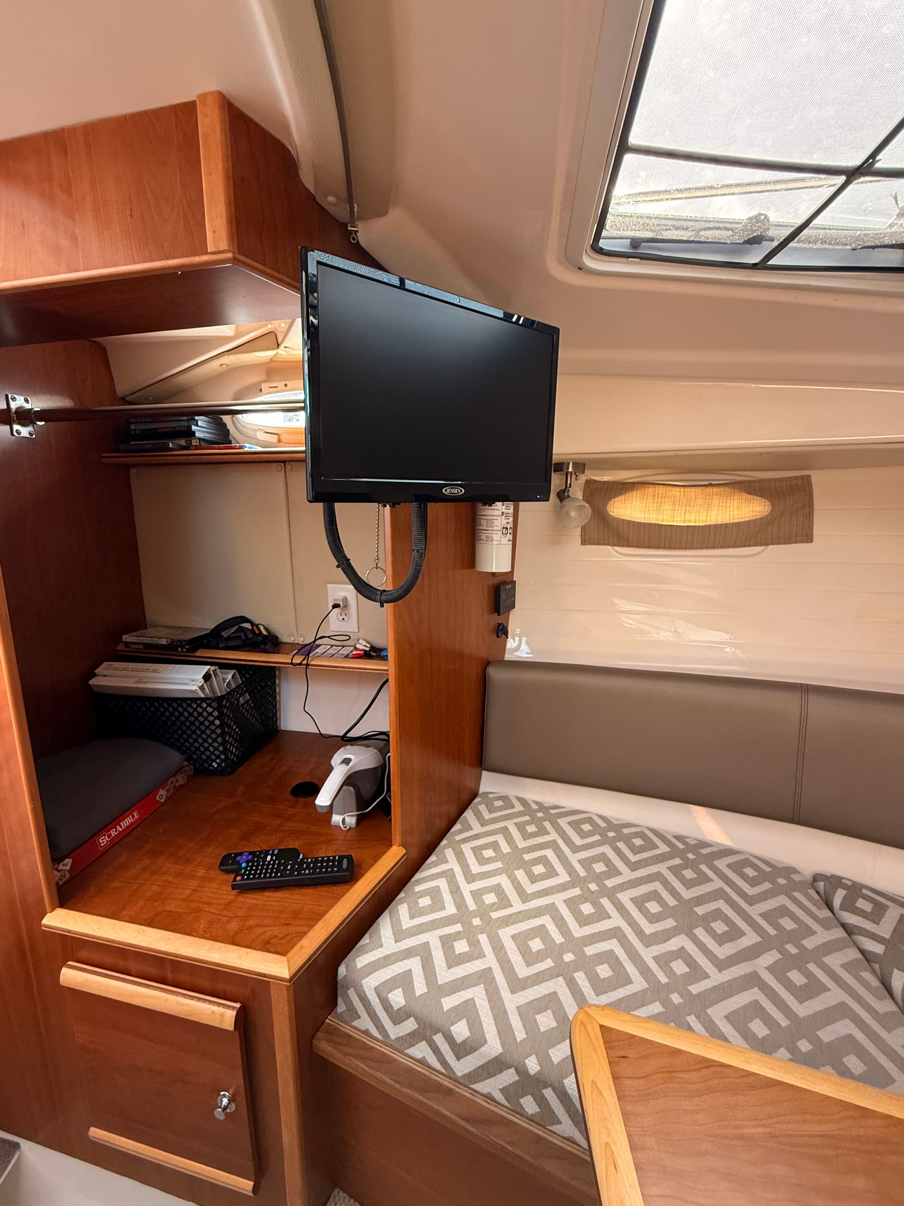 Interior of the Cutwater C-228 with cozy seating area and TV.