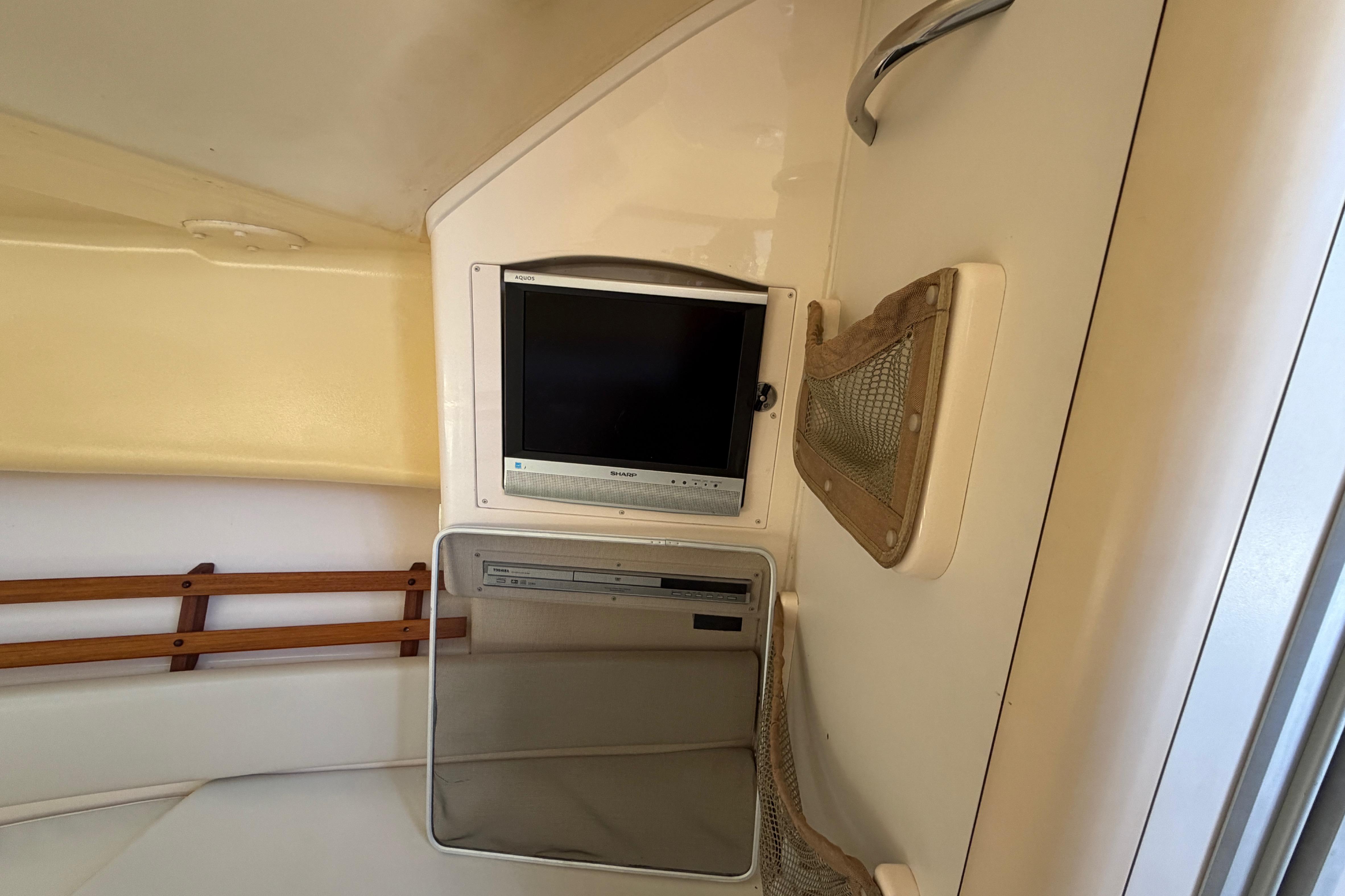 Interior of 2006 Grady-White Sailfish 282 with TV and storage compartments.