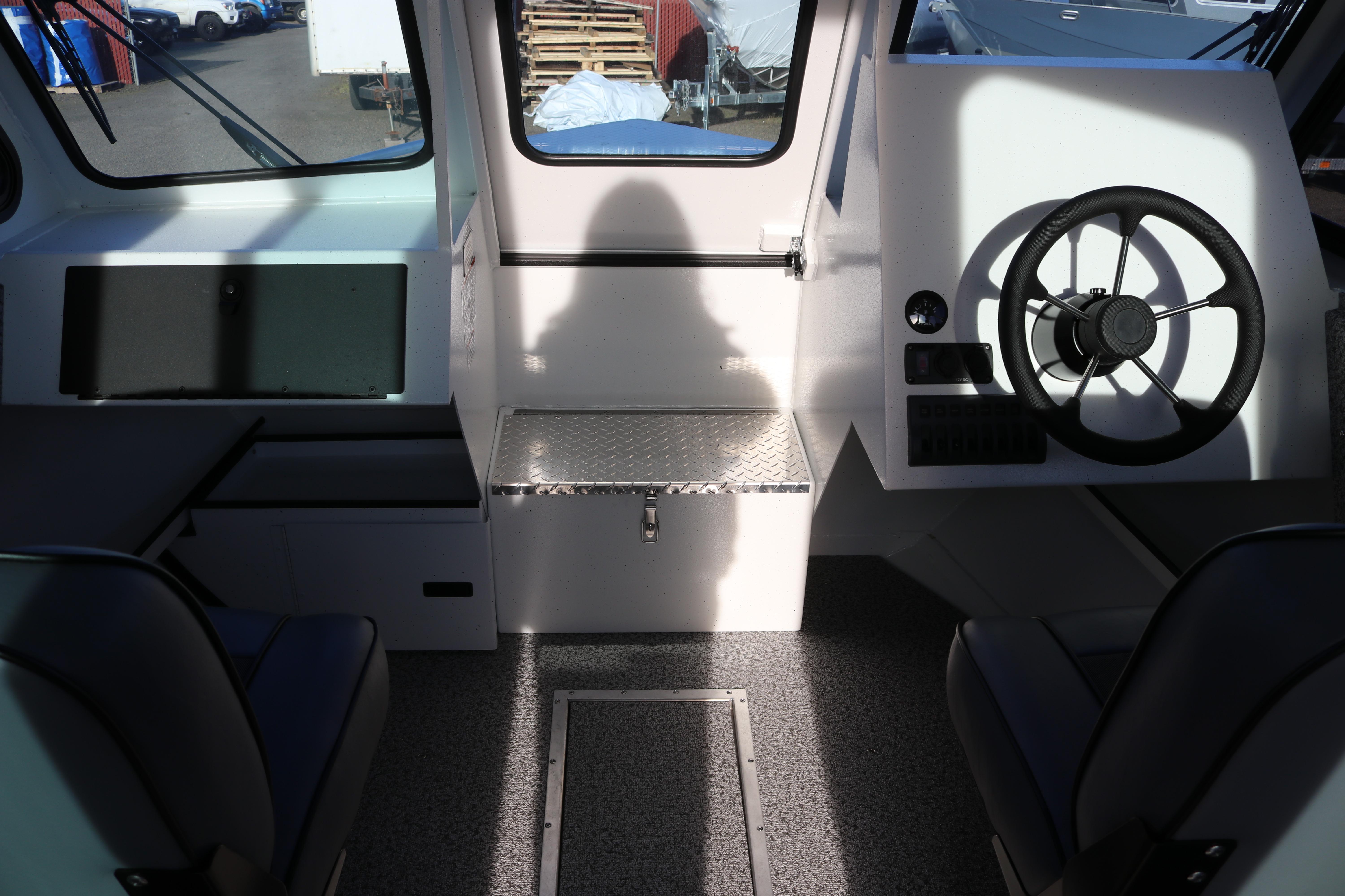 Interior of 2026 Alumaweld Intruder Outboard 22 boat, featuring steering wheel and seating.