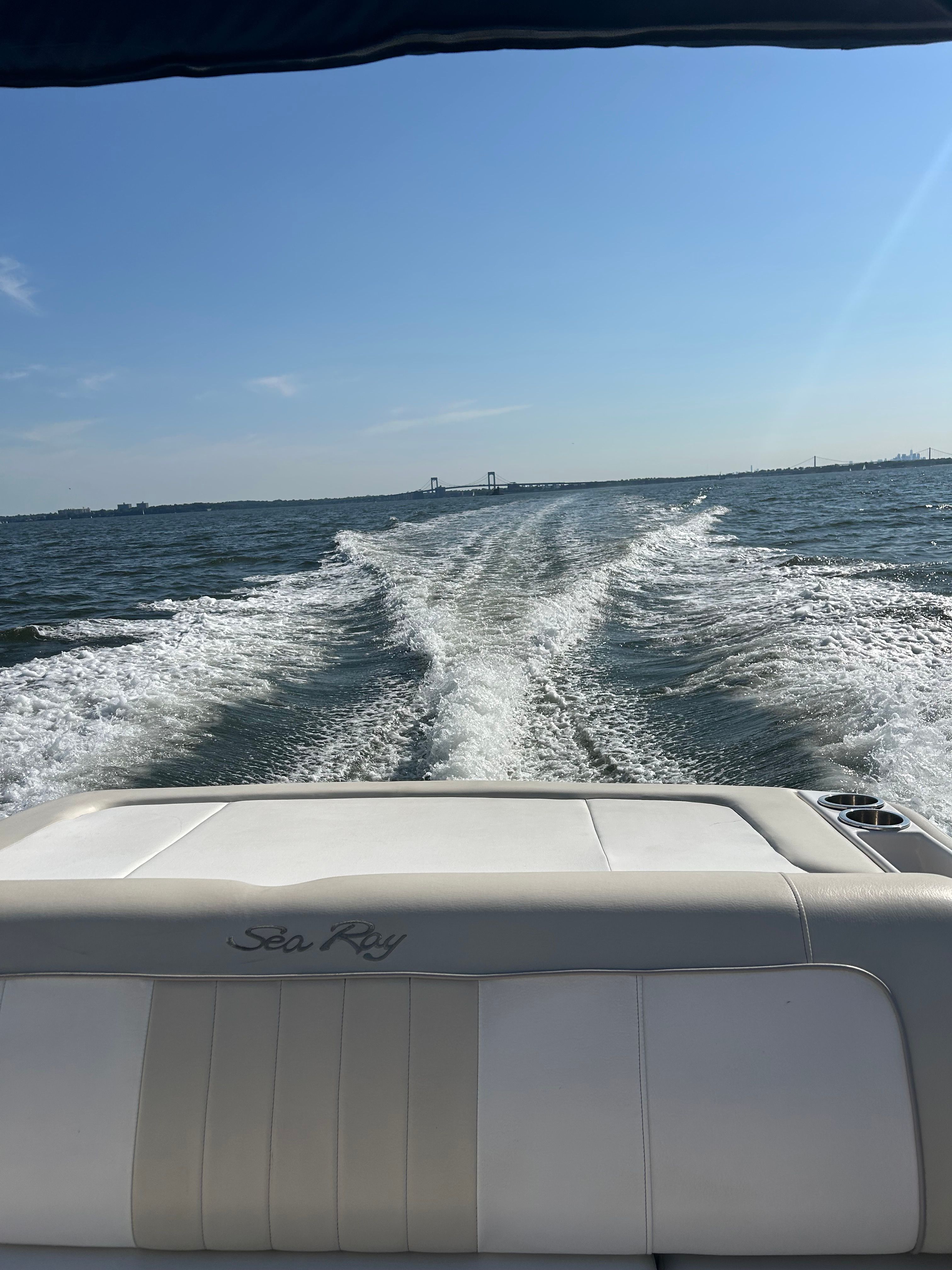 View from the stern of a Sea Ray 220 Sundeck over the water.