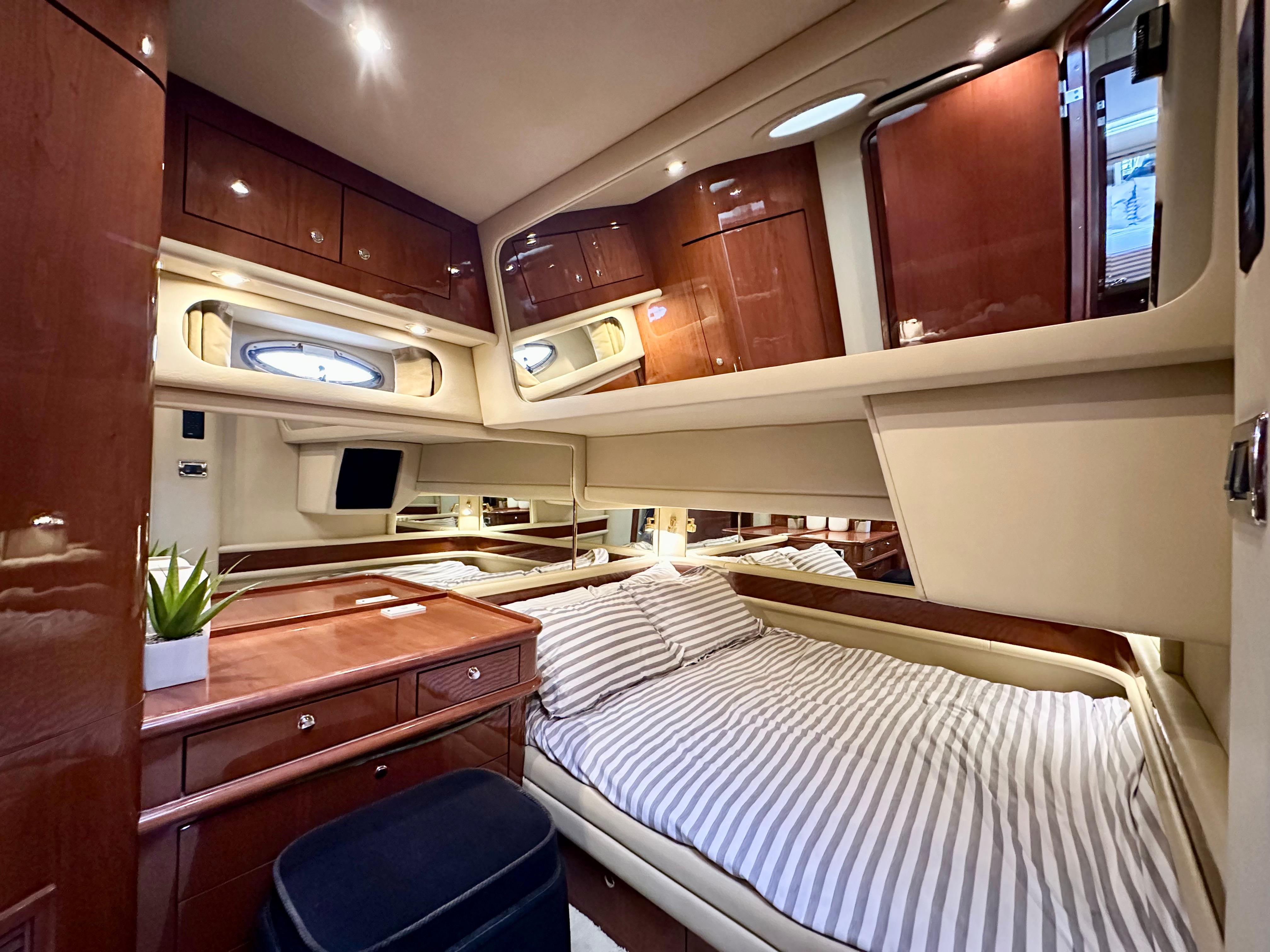 Luxurious cabin interior of 2002 Sea Ray 560 Sedan Bridge yacht with elegant wood finishes.