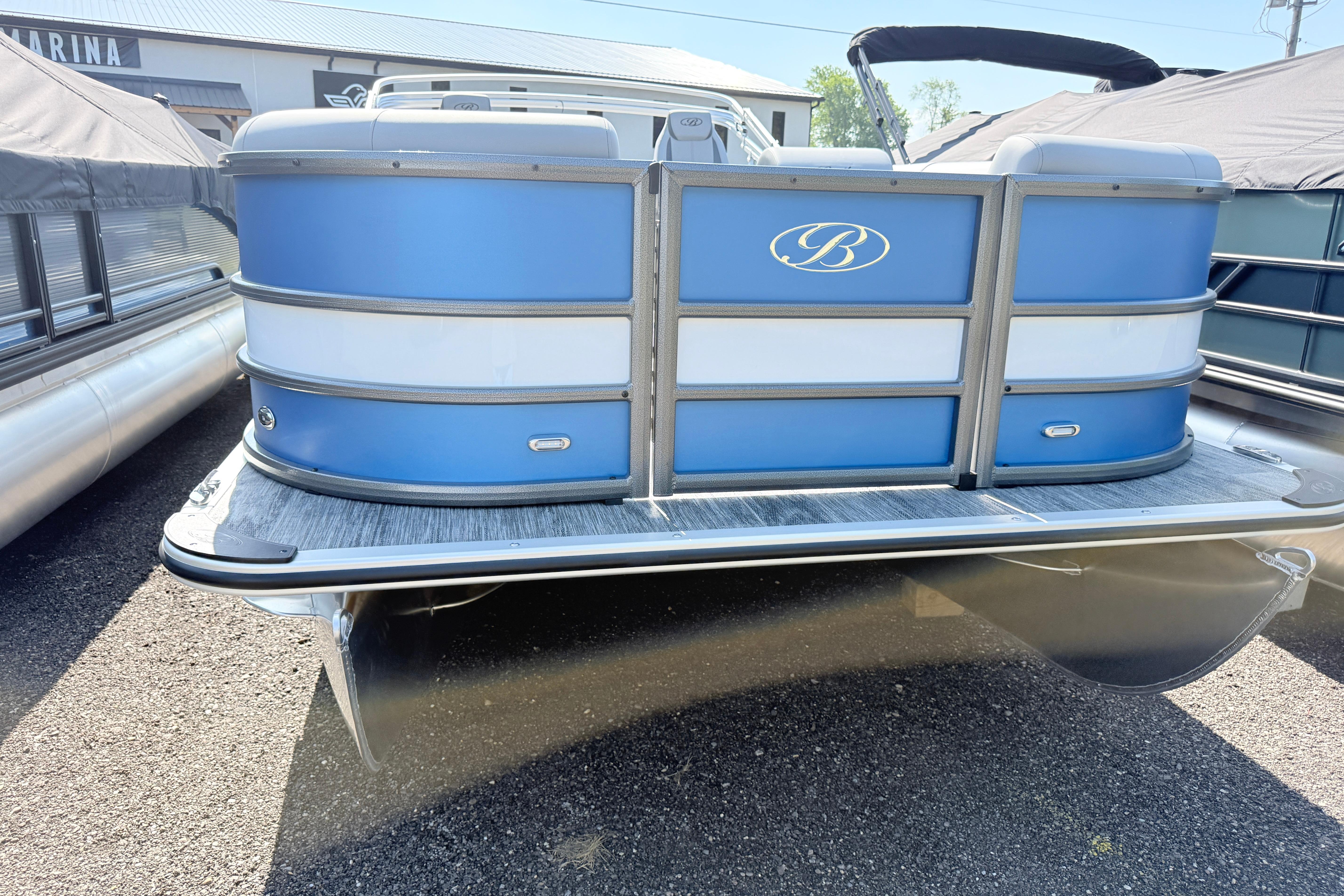 2027 Bentley Pontoons Legacy 240 Navigator, blue and white pontoon boat, parked outdoors.