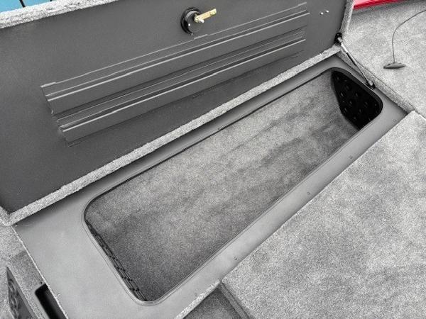 Open storage compartment in 2025 Tracker Savage 215 boat, featuring a secure lock mechanism.