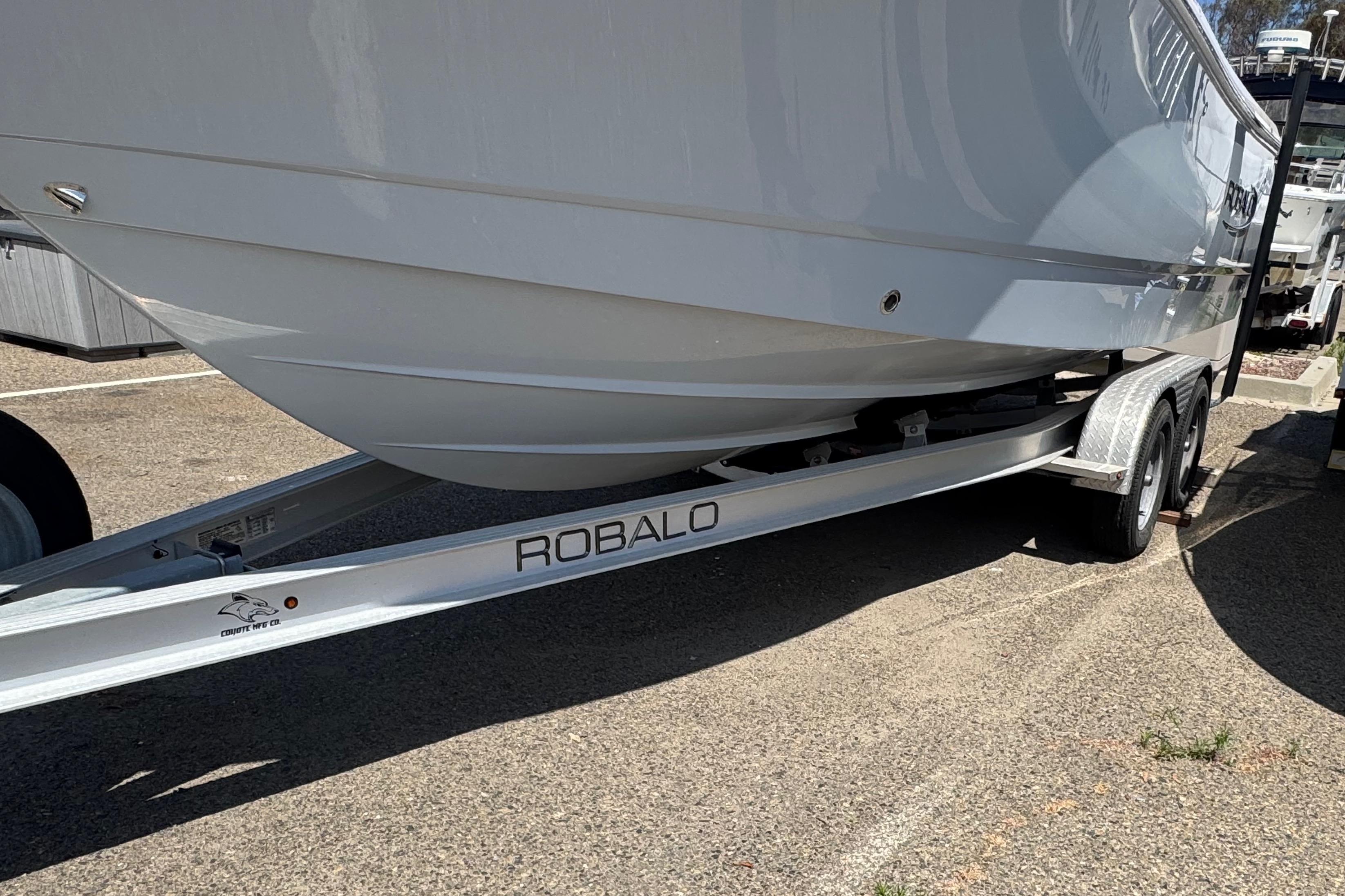 2022 Robalo R230 Center Console boat on trailer, parked outdoors.